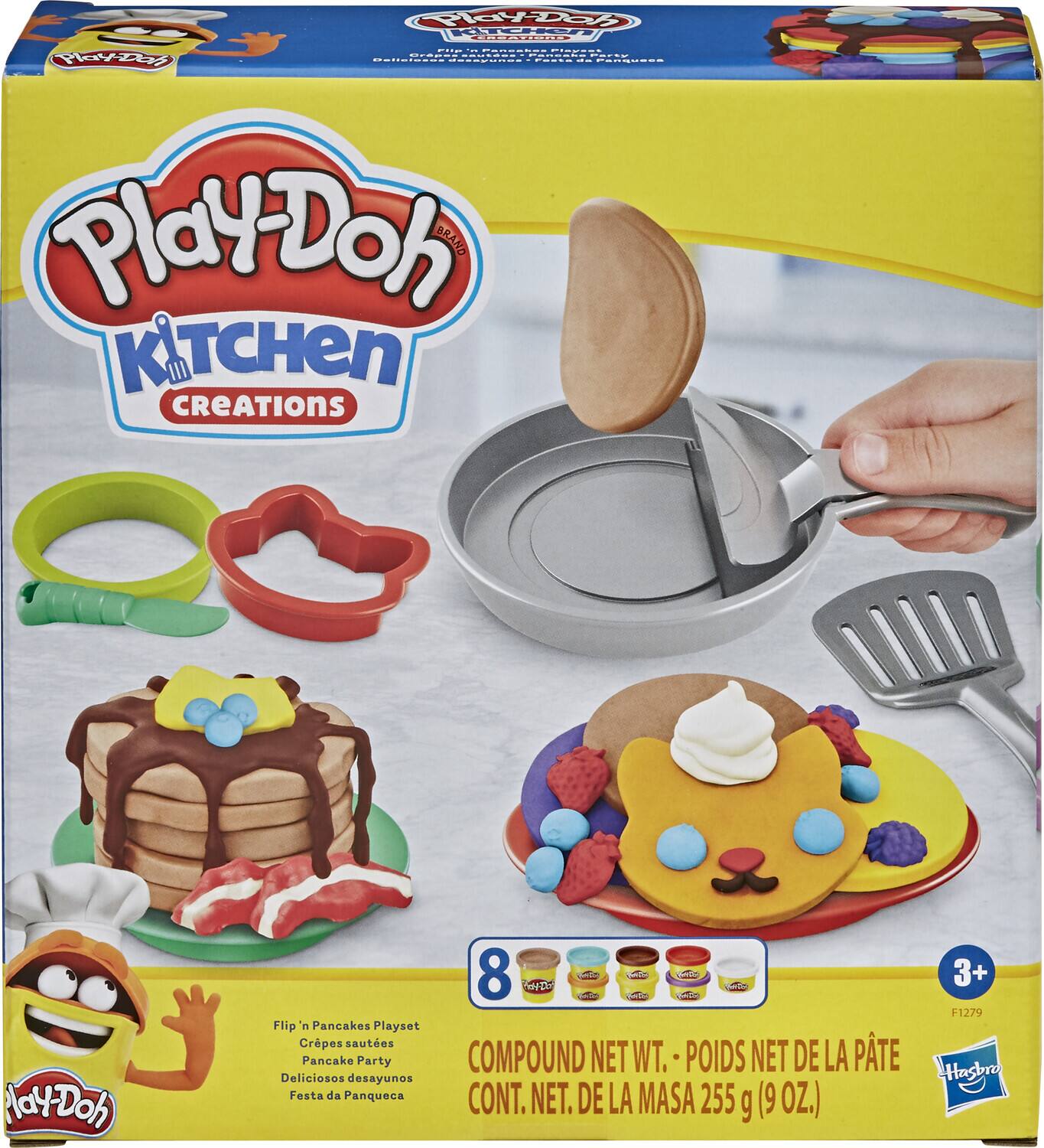The text on the image is:

"Play-Doh Kitchen Creations Nay-Doh 8 Int. Flip n Pancakes Playset Crêpes sautées Pancake Party COMPOUND NET WT. POIDS NET DE LA PÂTE Deliciosos desayunos Festa da Panqueca CONT. NET. DE LA MASA 255 g (9 OZ.) 3+ F1279 Hasbro"

Corrected and grouped:

"Play-Doh Kitchen Creations Nay-Doh 8 Int. Flip n Pancakes Playset Crêpes sautées Pancake Party COMPOUND NET WT. POIDS NET DE LA PÂTE: 255 g (9 OZ.) 3+ F1279 Hasbro"