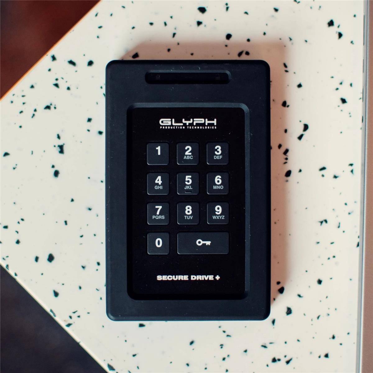 GLYPH PRODUCTION TECHNOLOGIES

1 ABC
2 DEF
3 GHI
4 JKL
5 MNO
6 PQRS
7 TUV
8 WXYZ
0

SECURE DRIVE +