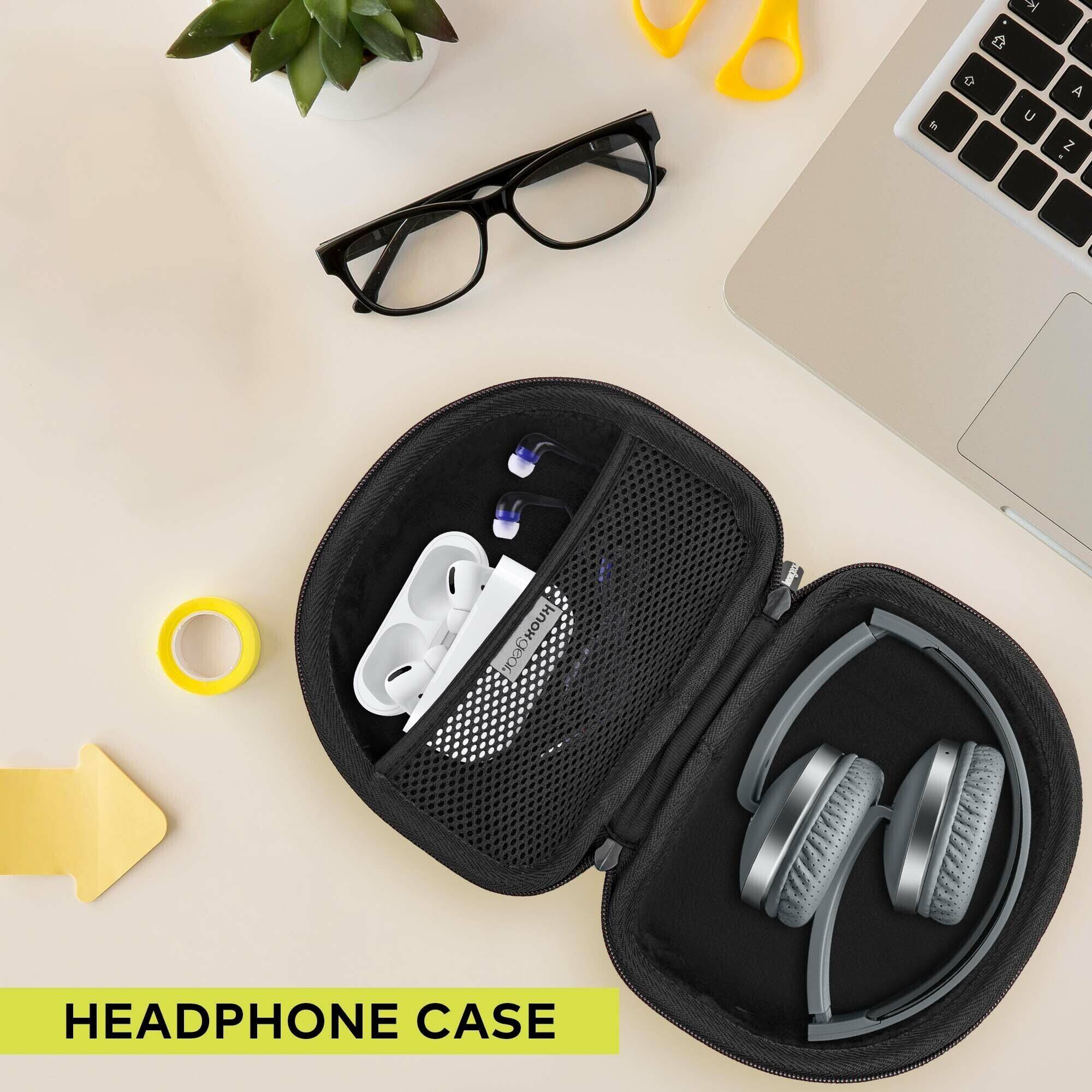 In the image, there is a headphone case with a pair of headphones and a pencil case. The headphones are placed in the case, and the case is sitting on a table. The headphones are black and white, and the pencil case is black. The table also has a laptop and a potted plant on it.