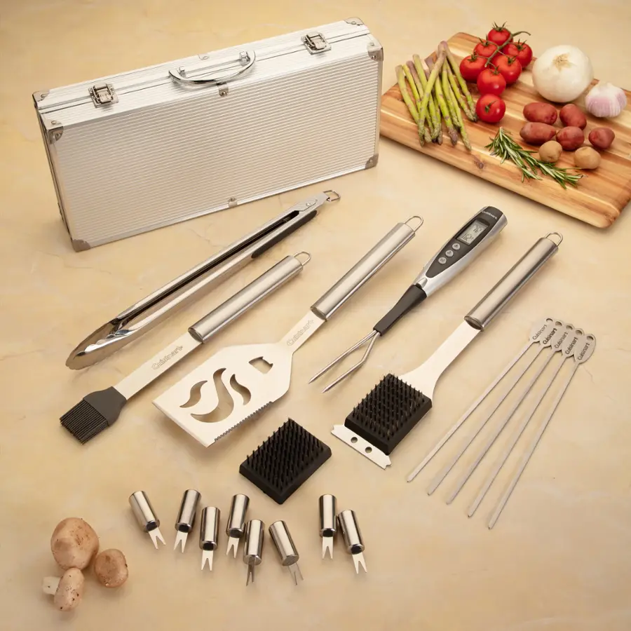The image features a variety of kitchen tools and utensils, including tongs, a spatula, a whisk, and a knife. These items are placed on a table, along with a cutting board and a suitcase. The suitcase appears to be a briefcase, and it is filled with various kitchen tools. The scene suggests that someone is preparing a meal or organizing their kitchen tools.