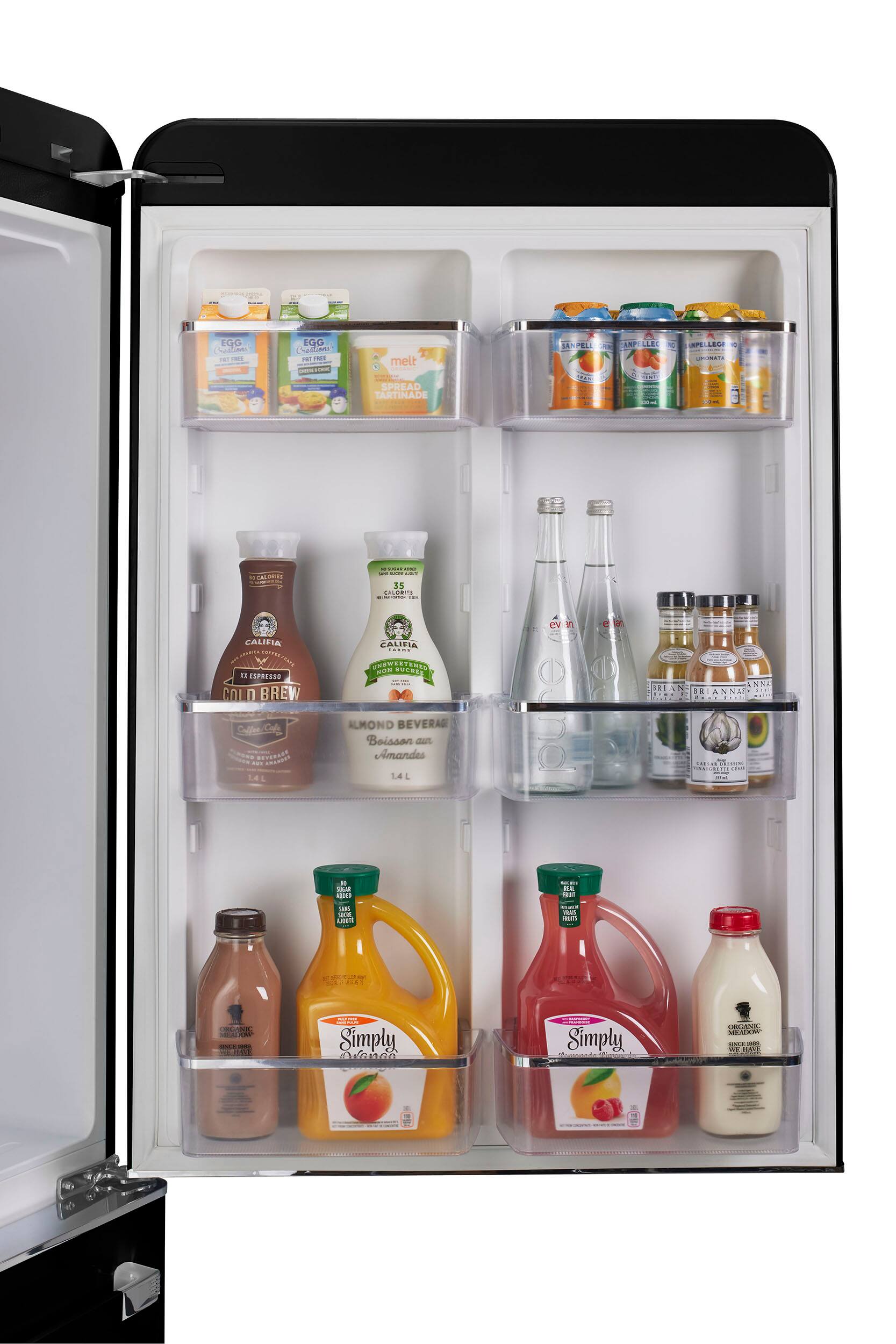 The image shows a refrigerator with its door open, revealing a variety of drinks and food items. There are several bottles of juice, milk, and other beverages, as well as a few bottles of almond milk. The refrigerator also contains a few bottles of wine, and some other food items such as yogurt and a sandwich. The refrigerator is well-stocked with a diverse selection of items to cater to different tastes and preferences.