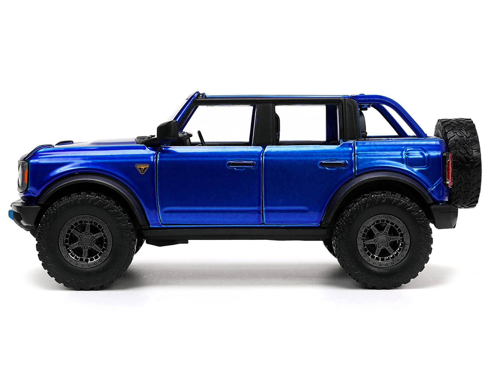 Left. Jada - 2021 Ford Bronco Open-Top Candy Blue Metallic with Extra Wheels "Just Trucks" Series 1/24 Diecast Model Car by Jada - Candy Blue Metallic.