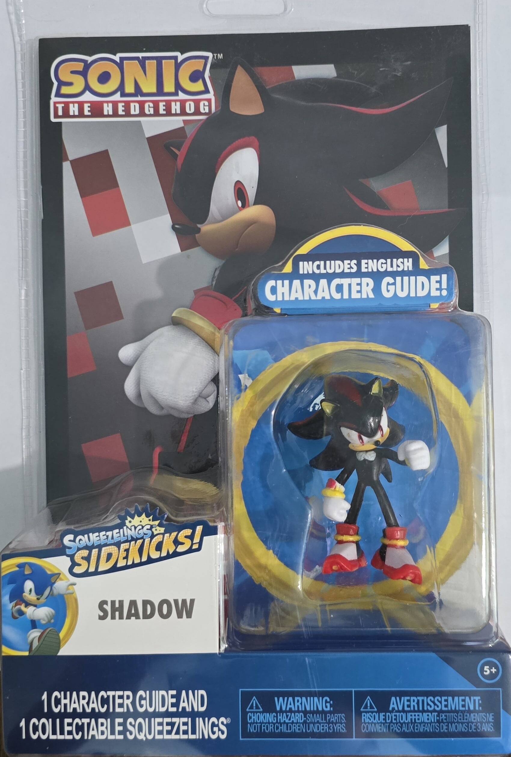 The text on the image can be grouped and corrected as follows:

**Sonic the Hedgehog**
- Includes English Character Guide!
- Squeezlings Sidekicks!
- Shadow 1 Character Guide and 1 Collectable Squeezlings

**Warning:**
- Choking Hazard - Small Parts. Not for children under 3 years.
- 5+ 

**Avantissement:**
- Risque d'étouffement - Petits éléments ne conviennent pas aux enfants de moins de 3 ans.