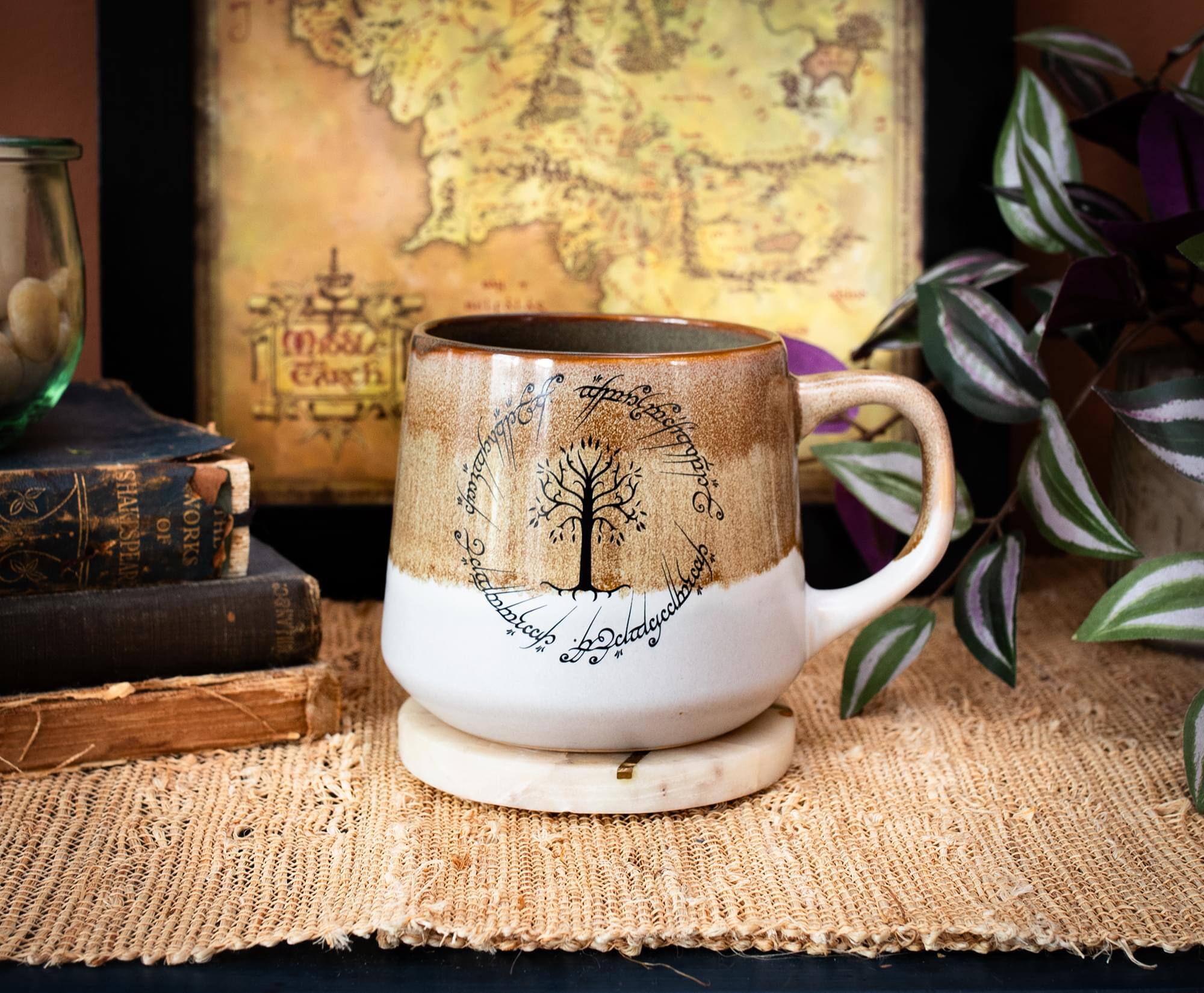 The text on the mug reads:

"J. SHARESPEAR OF WORKS THE (1180) isch rabgs days A ca Bdlagellbe"

This appears to be a stylized or artistic rendition of text, possibly referencing a historical or literary work. The text is arranged around a tree design on the mug.
