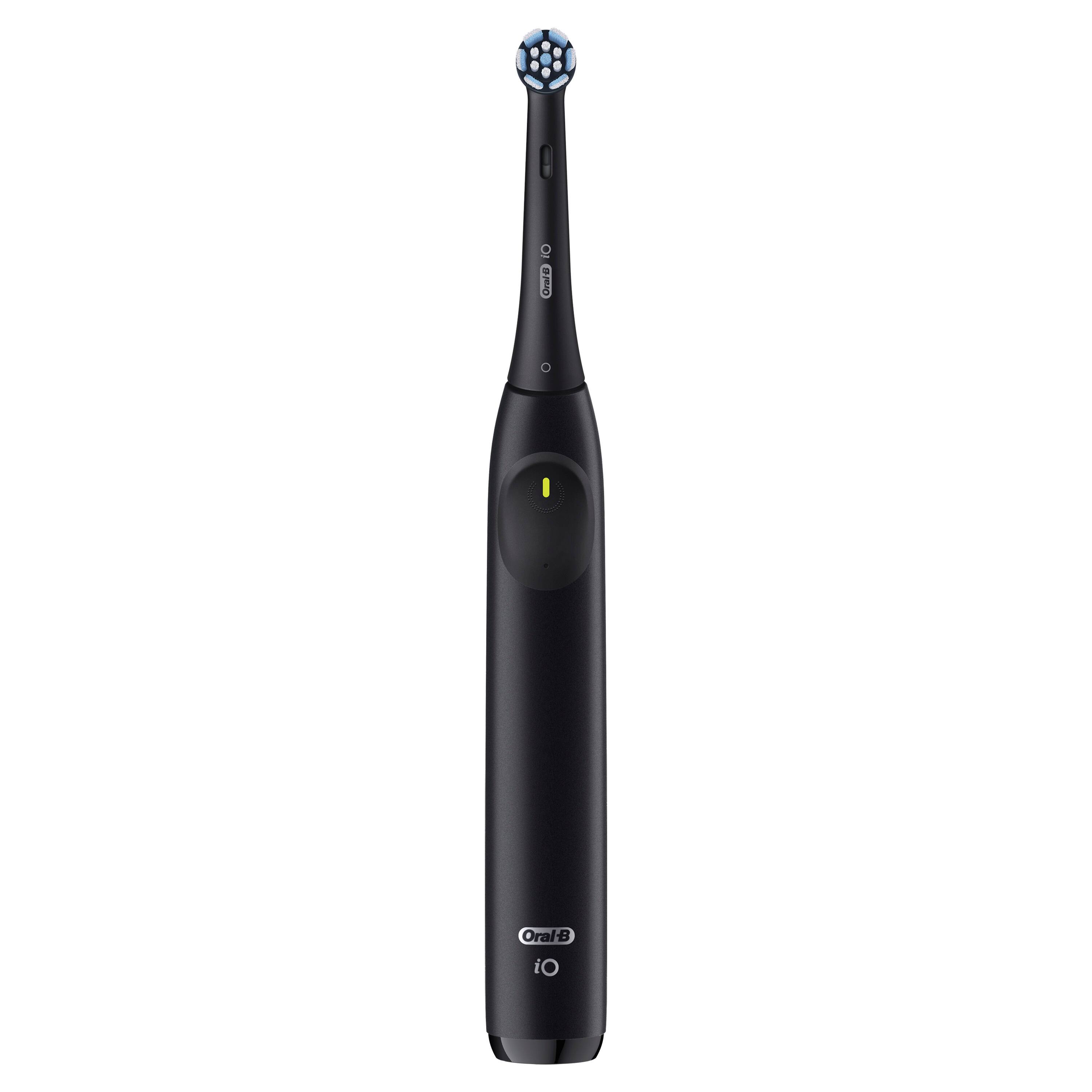 The image features a close-up of an electric toothbrush, specifically an Oral-B iO. The toothbrush has a blue head and a black handle. The toothbrush is positioned in a way that it appears to be floating in the air.