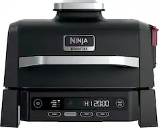 Ninja Woodfire Grill Smoker Bake Hoaster with a digital display showing the time and temperature. The device has a start and stop button for easy operation. The woodfire flavor adds a unique taste to the food being cooked.