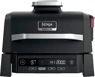 Ninja Woodfire Grill Smoker Bake Hoaster with a digital display showing the time and temperature. The device has a start and stop button for easy operation. The woodfire flavor adds a unique taste to the food being cooked.