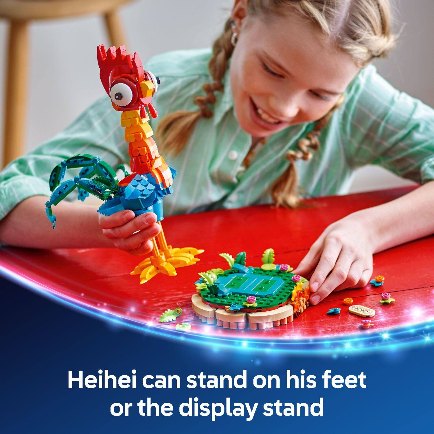 Heihei can stand on his feet or the display stand.