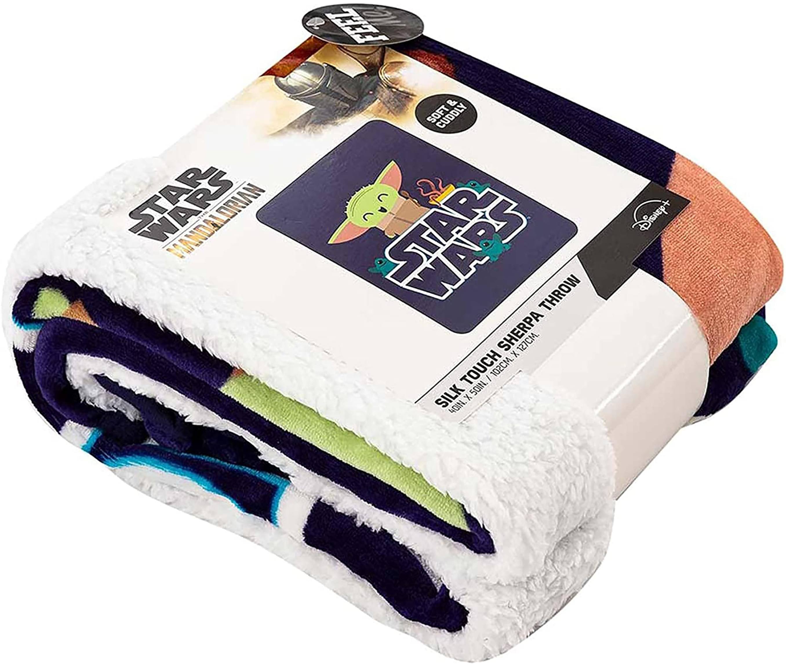 Sure, here is the corrected and grouped text from the image:

---

**STAR WARS**  
**MANDALORIAN**  
**MANDRA THROWN**  

**SILK TOUCH THROW**  
**127CM x 102CM**  
**100% SILK**  

**SOFT & Cuddly**  
**Disney**  

---

This text includes the product name, dimensions, material, and branding details.