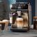 The image shows a coffee machine with a glass of milk and a glass of coffee on it. The coffee machine is a Philips brand.