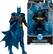 The image features a Batman action figure from the DC Multiverse line, which has 22 points of articulation. The figure is posed in a dynamic stance, with its arms outstretched. The packaging for the figure is also displayed, showcasing the Batman logo and the number 1,000,000. The figure is likely part of a collectible series, as it is designed to be displayed on a shelf or in a collection.