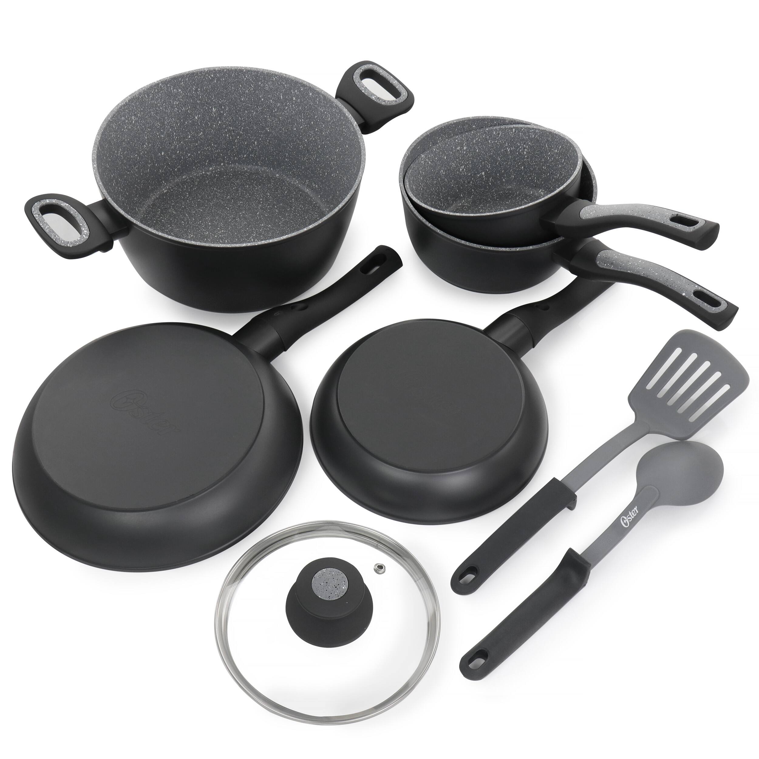 The image shows a collection of black cooking utensils, including a frying pan, a skillet, a spatula, a fork, and a bowl. The cookware is placed on a white background, making the items stand out. The frying pan is positioned on the left side of the image, while the skillet is located in the middle. The spatula is placed on the right side, and the fork is situated towards the top right corner. The bowl is located in the bottom right corner of the image.
