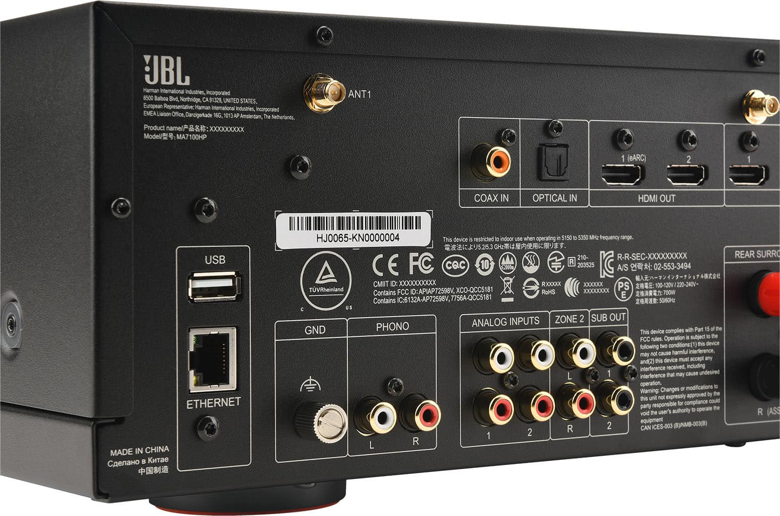 The text on the image is:
"UBL Haman international Industries incorporated 8500 Balboa Blvd, Northridge, CA 91329, UNITED STATES. European Representative Haman international Industries, incorporated EMEA Liaison Office, Danzigerade 16G 1013AP The Amsterdam, Netherlands. Product name/? : XXXXXXXXx Model/: MA7100HP ANT1 1 (BARC) 2 1 COAX IN OPTICAL IN HDMI OUT USB ETHERNET MADE IN CHINA HJ0065-KN0000004 This device S restricted to indoor use when operating e 5150 D 5350 MH2 frequency range. 5.25.3 210- R-R-SEC-XXXXXXXXX FC CQc 10 R 203525 CE A/S : 02-553-3494 CMIT Dc XXXXXXXXXX RXXXXX XXXXXX PS TVRheinland FCC ID: APIAP72598V, XCO-QCC5181 RoHS XXXXXXXXXXxX Contains E 7OOW Contains IC-6132A-AP72598V, 7756A-QCC5181 5060 C US INPUTS ZONE 2 SUB OUT PHONO ANALOG GND complies with Part 15 of the This device Operation . subject to the FCC rules. conditions: this device following two cause harmful interference, may not this device must accept any and(2) interference receiv"