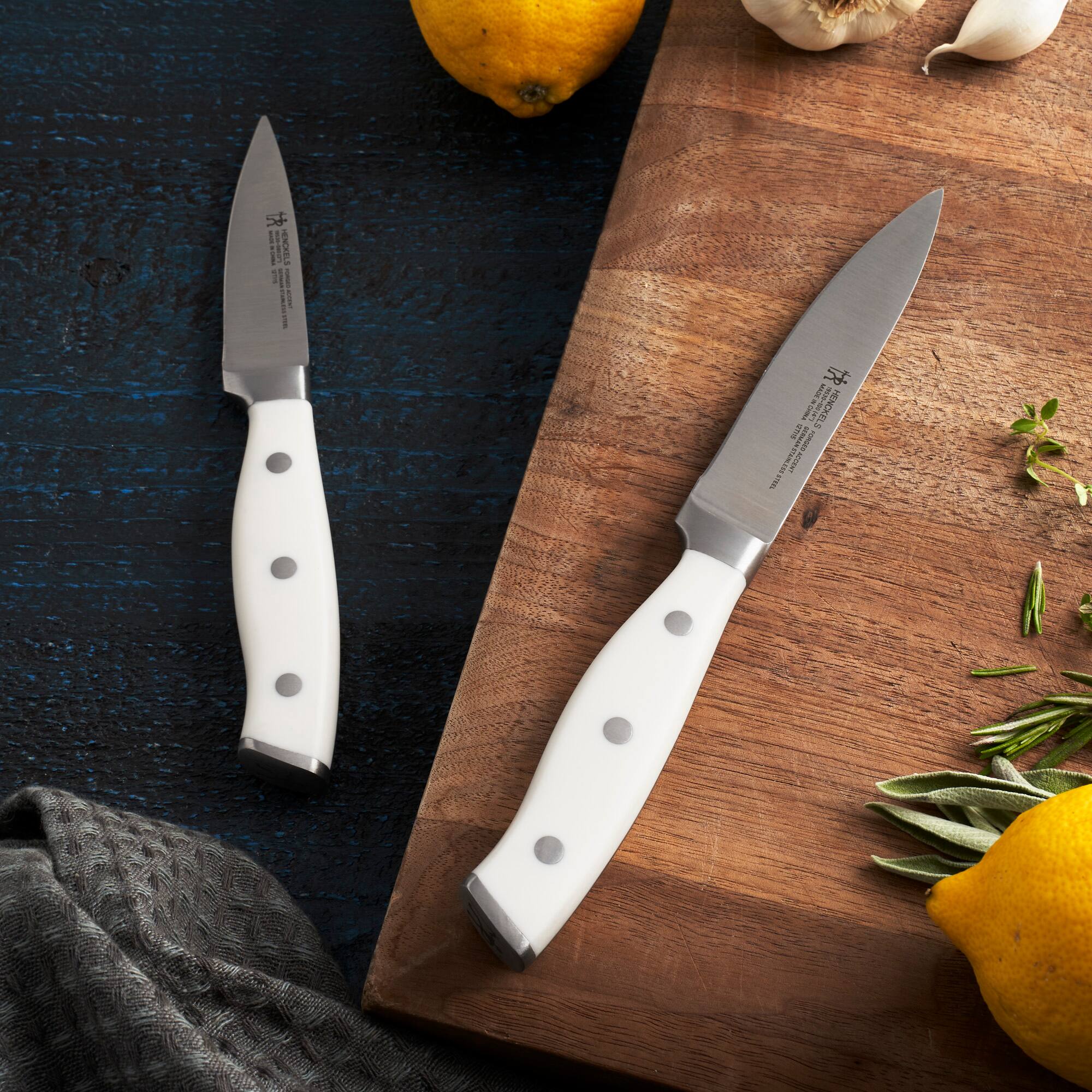 The text on the knives reads:

"J.A. Henckels
IMPROVED
STAINLESS
GERMANY
MADE IN GERMANY
100% STAINLESS
HIGH CARBON
FOR PROFESSIONAL USE
MADE IN GERMANY"