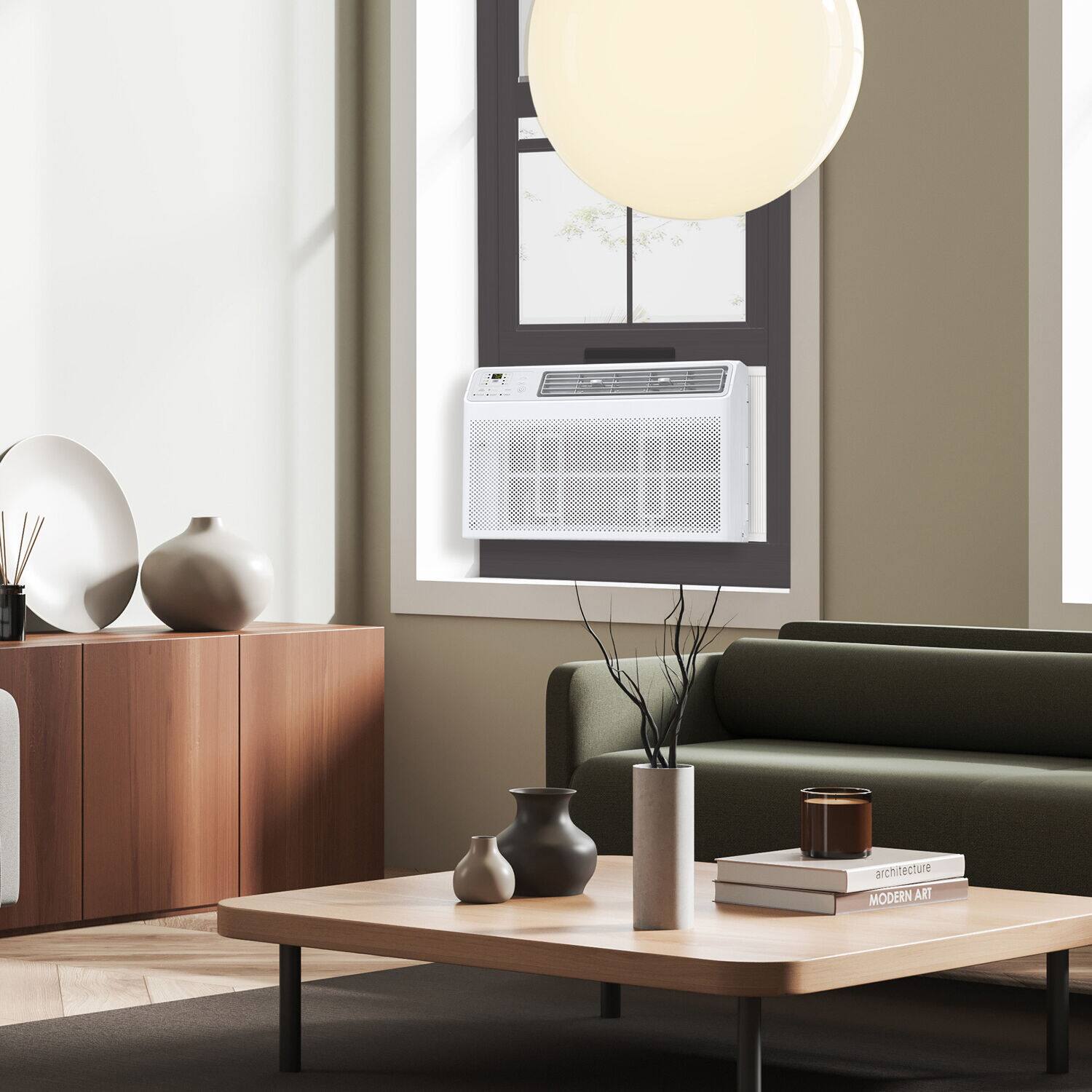 The living room features a modern art design, with a large window that allows natural light to flood the space. The room is furnished with a couch, a coffee table, and a vase, creating a comfortable and stylish atmosphere. The coffee table is adorned with a vase and a book, adding to the room's aesthetic appeal. The presence of a window air conditioner suggests that the room is well-equipped for maintaining a comfortable temperature. Overall, the living room exhibits a contemporary and inviting ambiance.