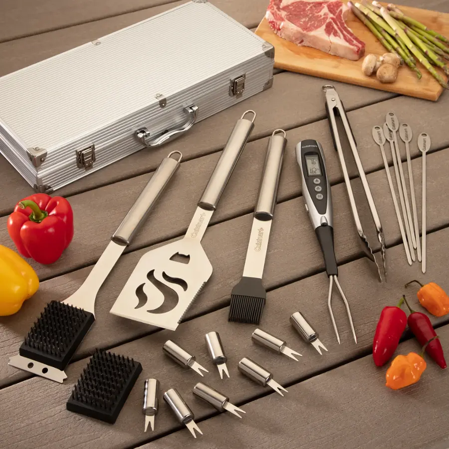 The image features a variety of cooking utensils and ingredients, including tongs, a grill, a cutting board, and a case of meat. The tongs are placed on the cutting board, and the case of meat is on a table. There are also several peppers and a tomato present in the scene. The arrangement of these items suggests that someone is preparing a meal using these tools and ingredients.