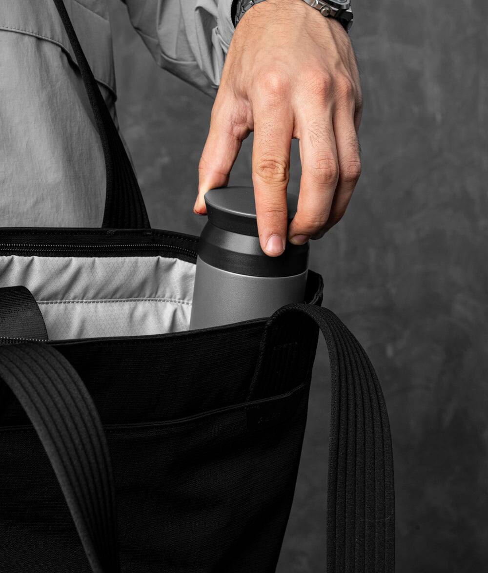 Alt View 1. ALPAKA - Flight Tote (M) Laptop Tote Bag for Work, Tote Bag Fits 14" MacBook Pro, Water Bottle Pocket, Luggage Pass-Through - Black Axoflux 400D.