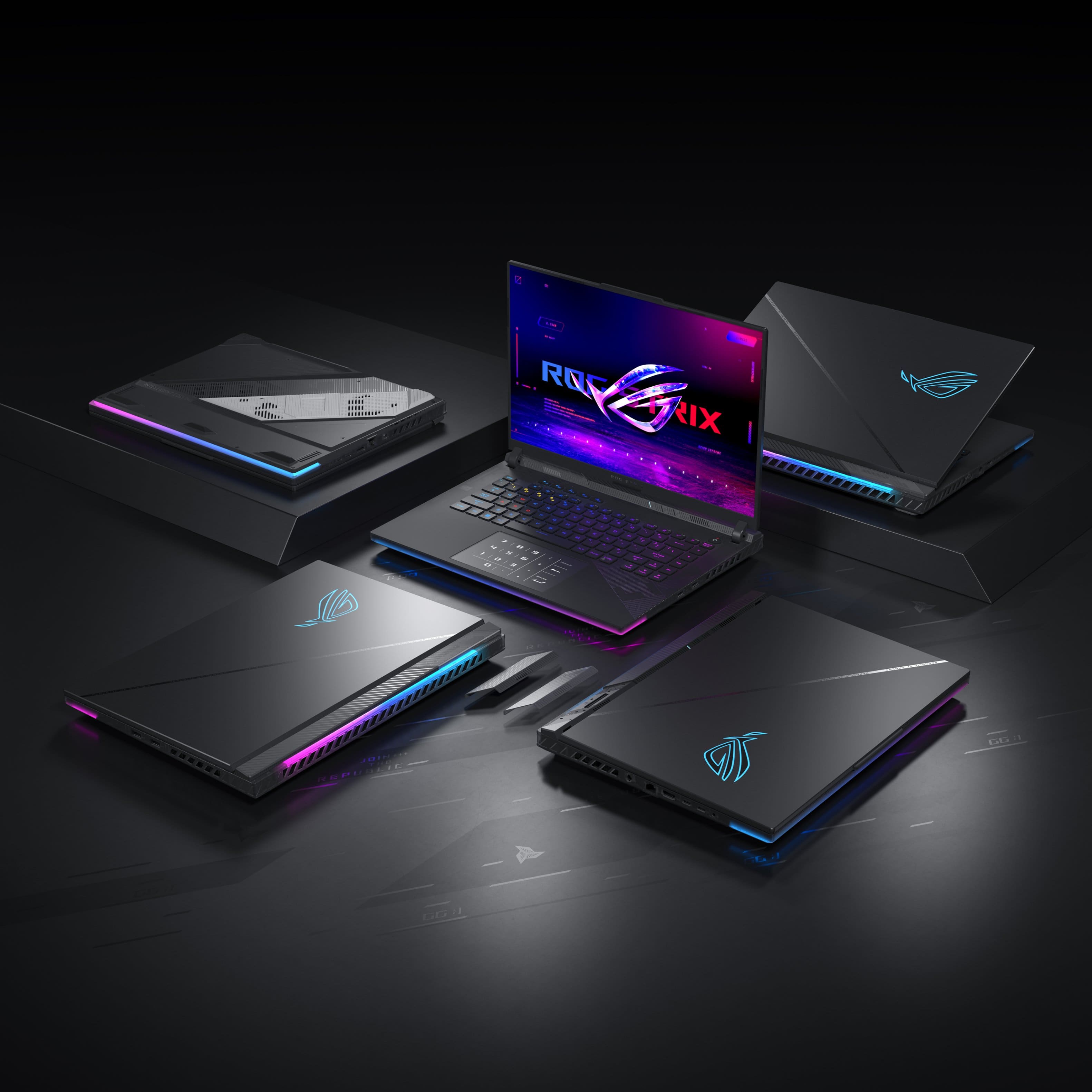 The image displays a total of four laptop computers, with one laptop open and turned on. The laptops are arranged in a square formation, with each laptop occupying one side of the square. The open laptop is positioned in the center of the square, while the other three laptops are placed around it. The laptops are all black and have a purple glow, giving them a sleek and modern appearance.