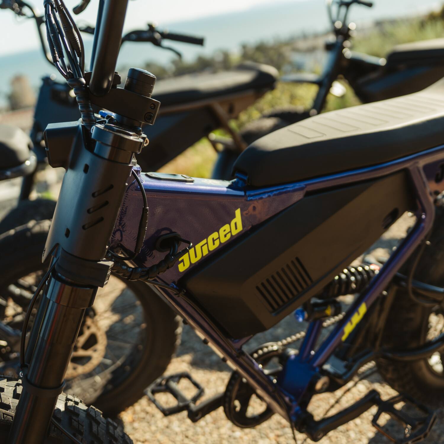Alt View 6. Juiced Bikes - Scrambler Full Suspension eBike (Max 60mi/28mph) + Headplate/Handlebar Bag & Pad/Fenders/Sticker Pack - Grape Juice.