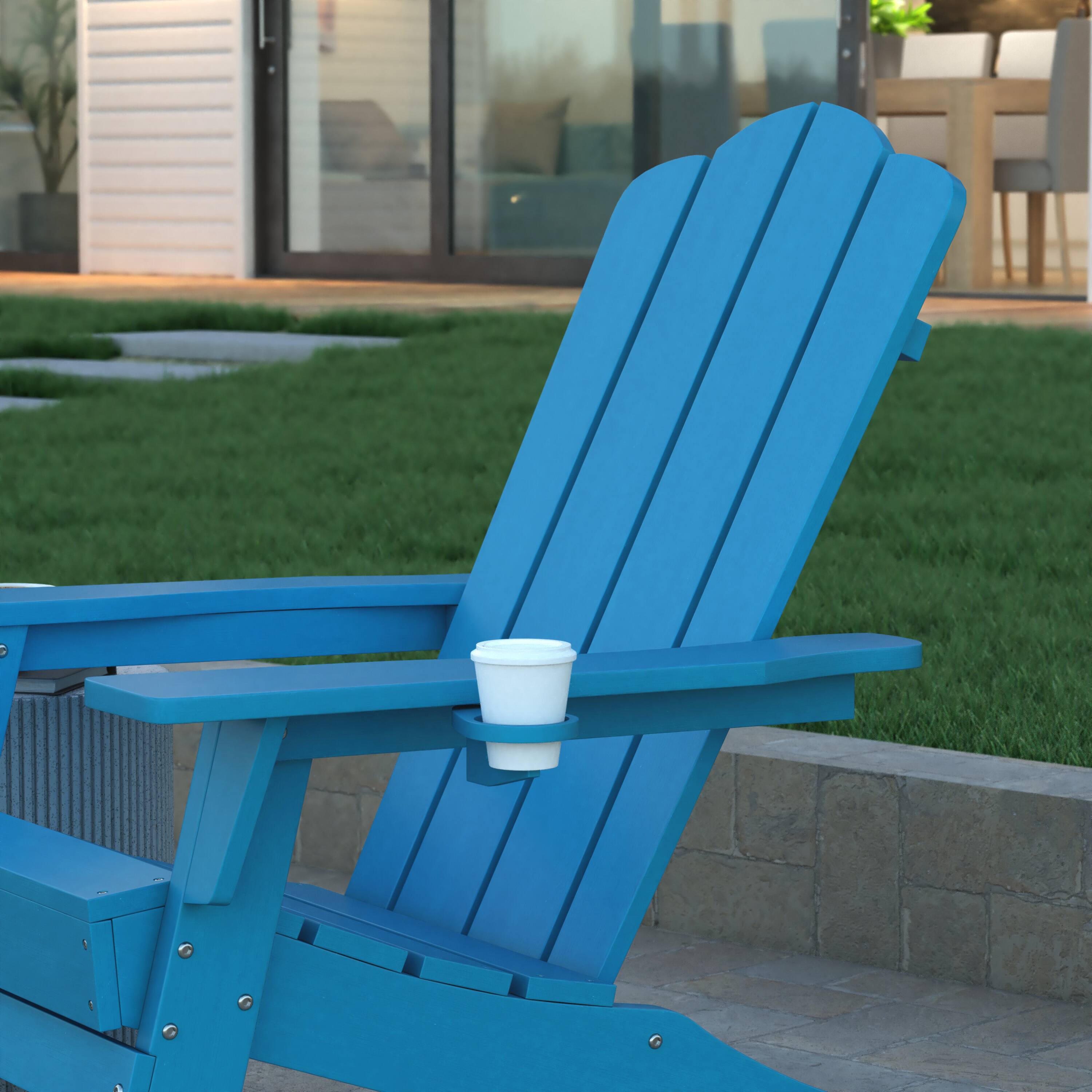 Blue Adirondack rocking chair with a white cup on the armrest.