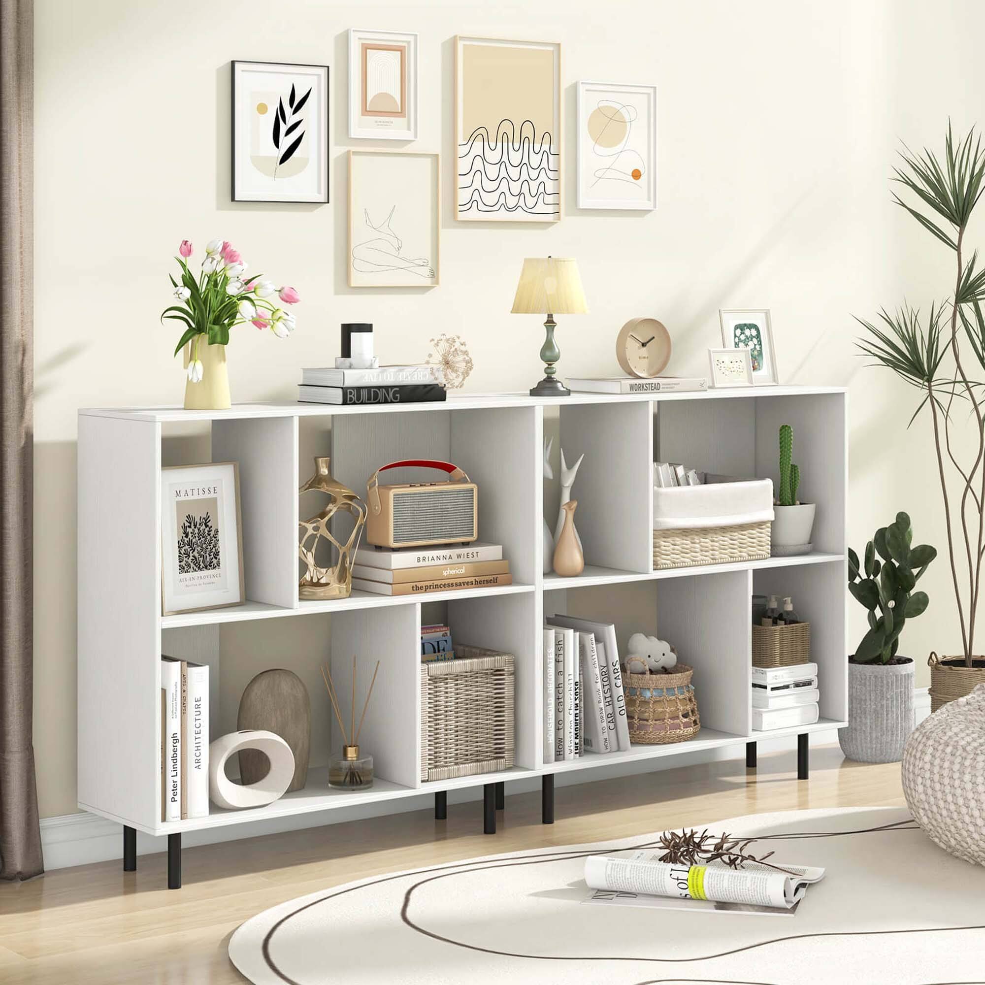 The image features a white bookshelf filled with various items, including books, a clock, and a vase. The bookshelf is situated in a living room, and there is a potted plant nearby. The scene also includes a couch and a chair, creating a cozy and inviting atmosphere. The bookshelf is a central element in the room, showcasing the homeowner's taste and interests.