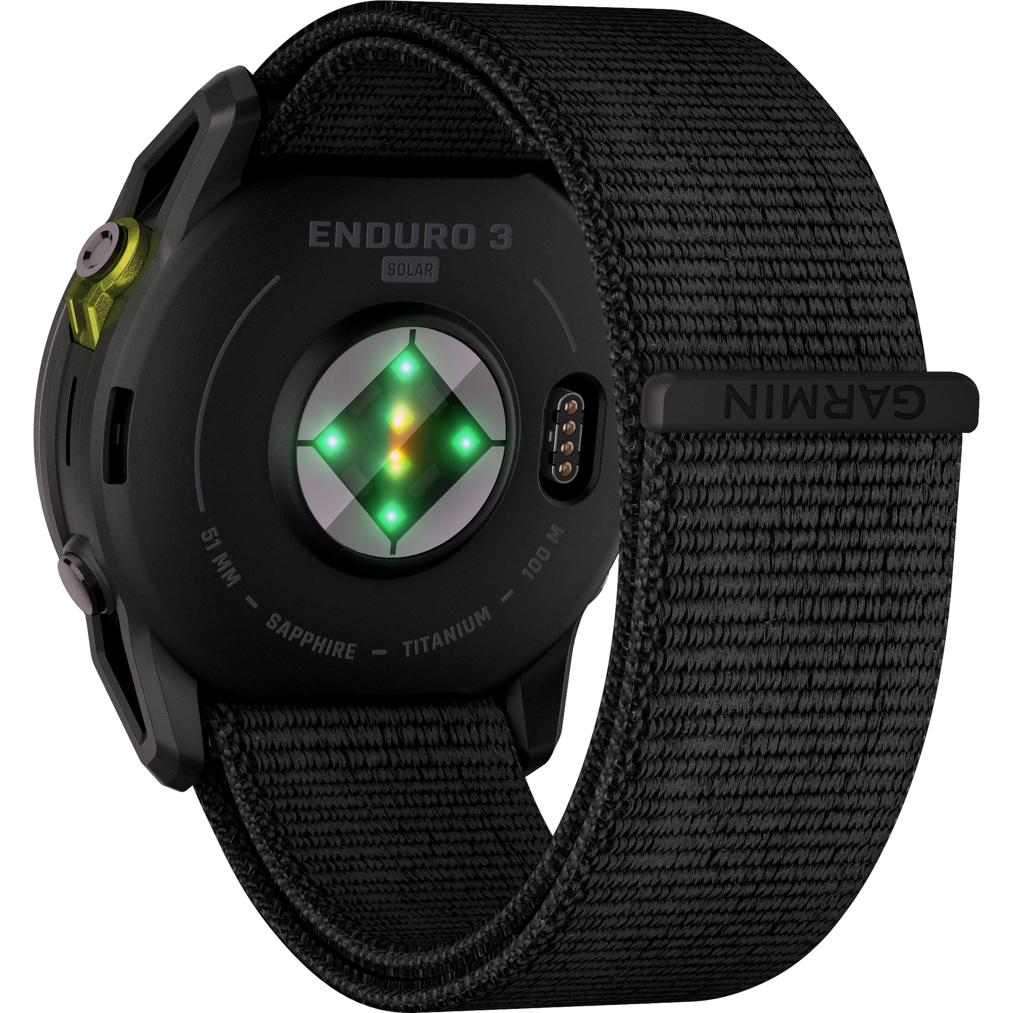 The text on the image reads "ENDURO 3 SOLAR GARMIN 51 M 100 - I SAPPHIRE - TITANIUM". This is a description of a watch that features solar power and is made of titanium. The watch is designed by Garmin and has a sapphire face.