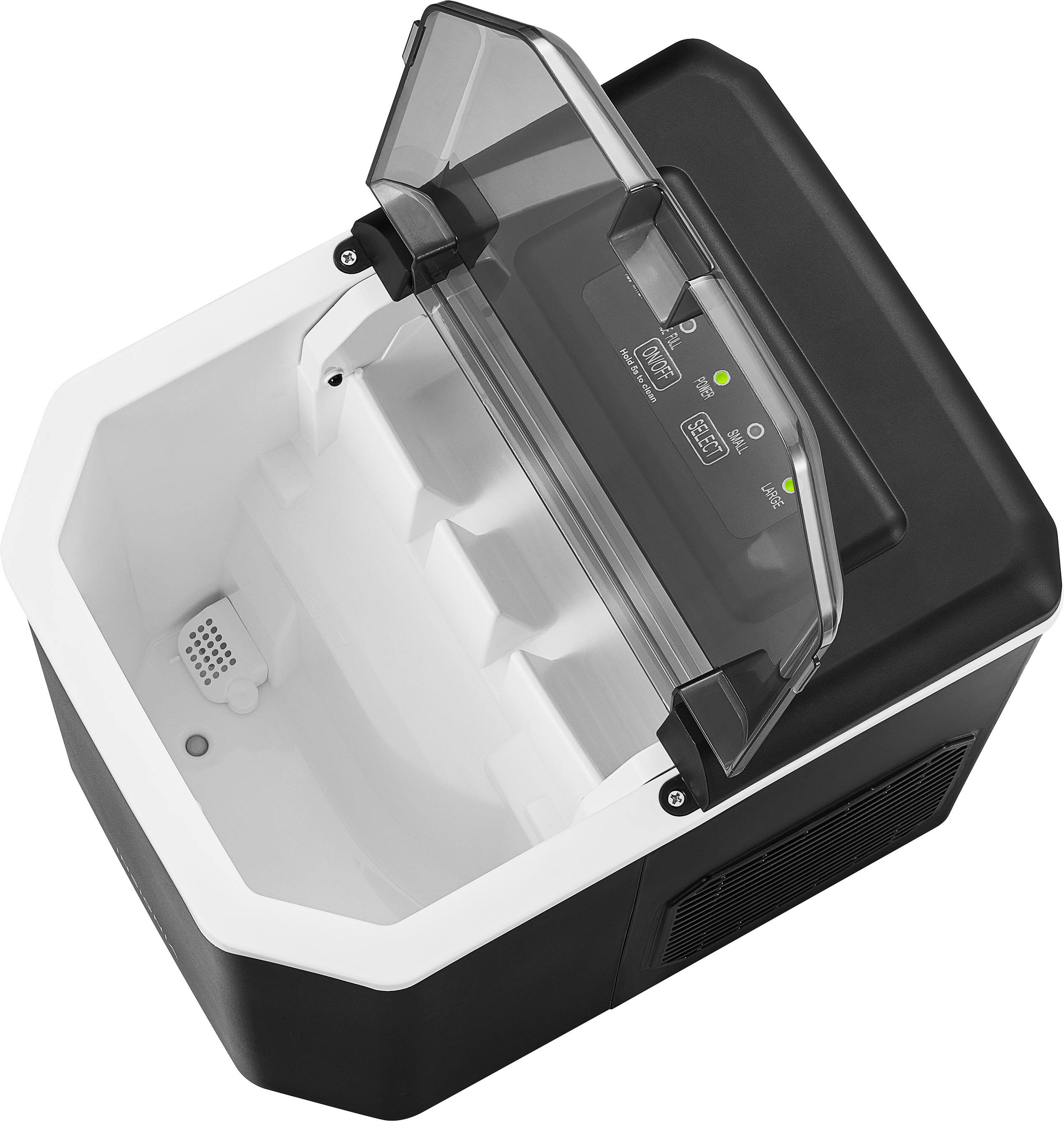 The image shows a black and white machine with a clear plastic cover. The machine has a green light on it, indicating that it is on. The machine is designed to hold a tray, and it is currently empty. The machine is likely used for food preparation or storage, given its size and the presence of the clear plastic cover.