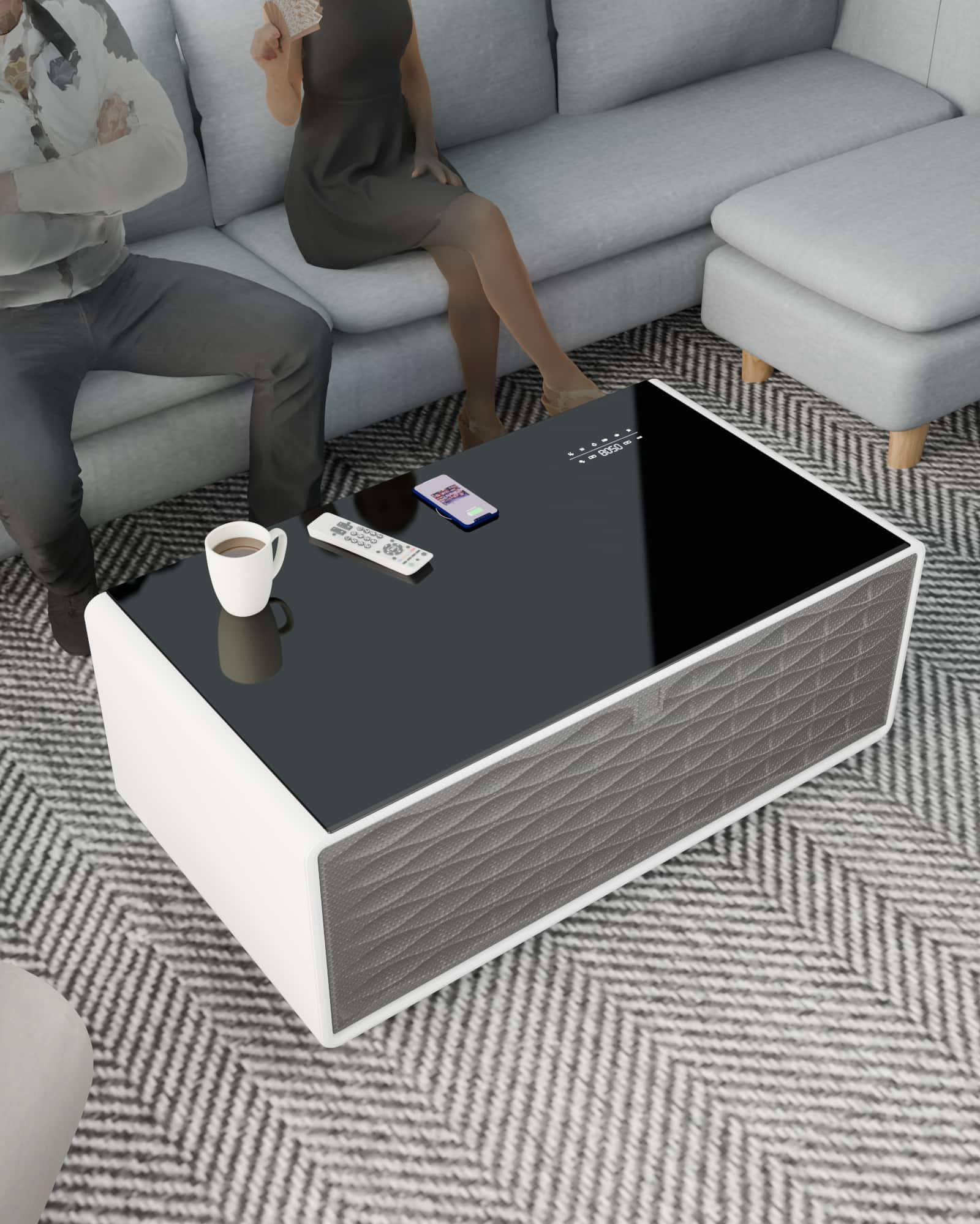 The text on the image reads "dhe da M22D - CO. - S- -". However, it is not clear what this text represents or its relevance to the image. The image shows a man and a woman sitting on a couch, with a coffee table in front of them. The table has a remote control and a cell phone on it.