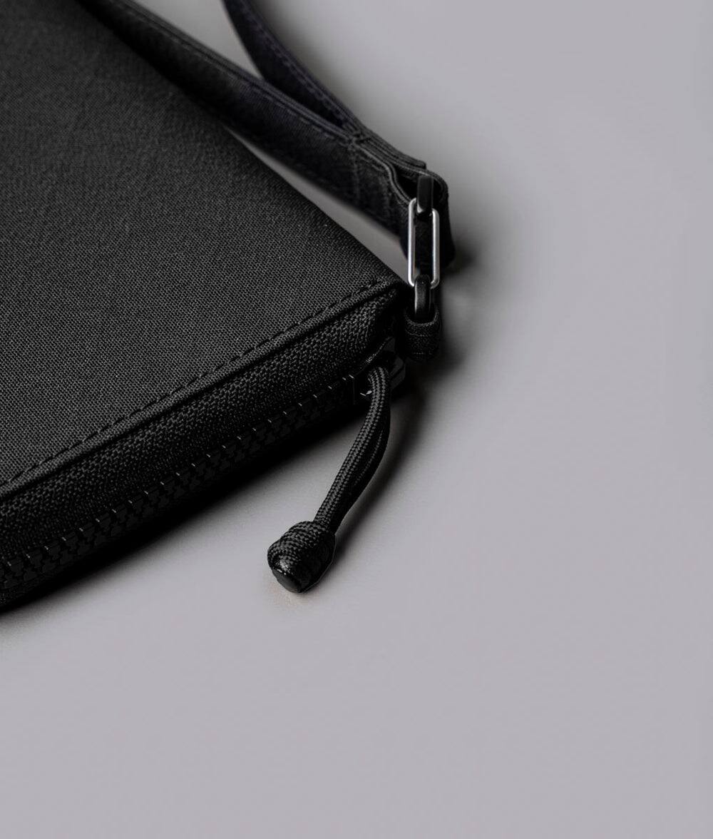 Alt View 7. ALPAKA - RFID Zip Passport Wallet with Boarding Pass Pocket, 7 Card Slots, Magnetic Flaps, Detachable Hand Strap - Black Axogrid 300D.