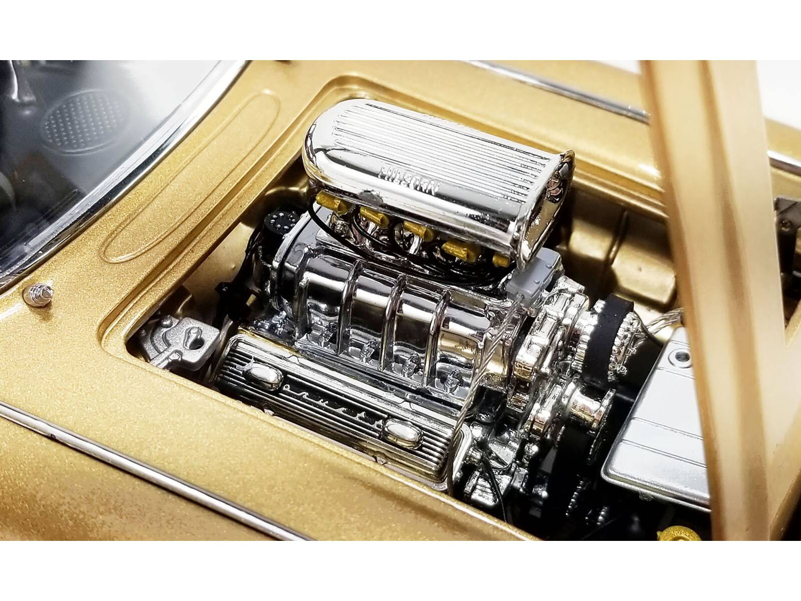 Left. ACME - 1961 Chevrolet Corvette Gasser Rat Fink's The Fugitive Vette Gold Metallic Limited Edition to 414 pieces Worldwide 1/18 - Yellow.