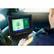 The image shows a person using a laptop computer in a car. The laptop is open and displaying a fingerprint image on the screen. The person is likely a police officer or a security professional, as they are using the laptop for identification purposes. The car's interior is visible in the background, with a car seat and a window. The person is sitting in the car, focused on their work.