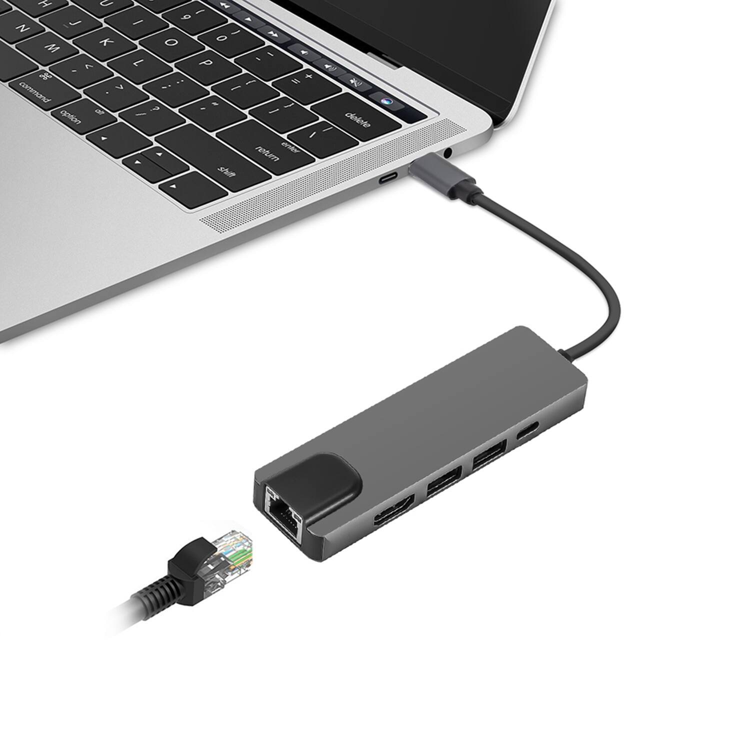 The image shows a laptop with a small device connected to it. The device has a USB plug in it, which is plugged into the laptop. The laptop is open, and the device is placed next to it. The device is likely used for data transfer or charging purposes.