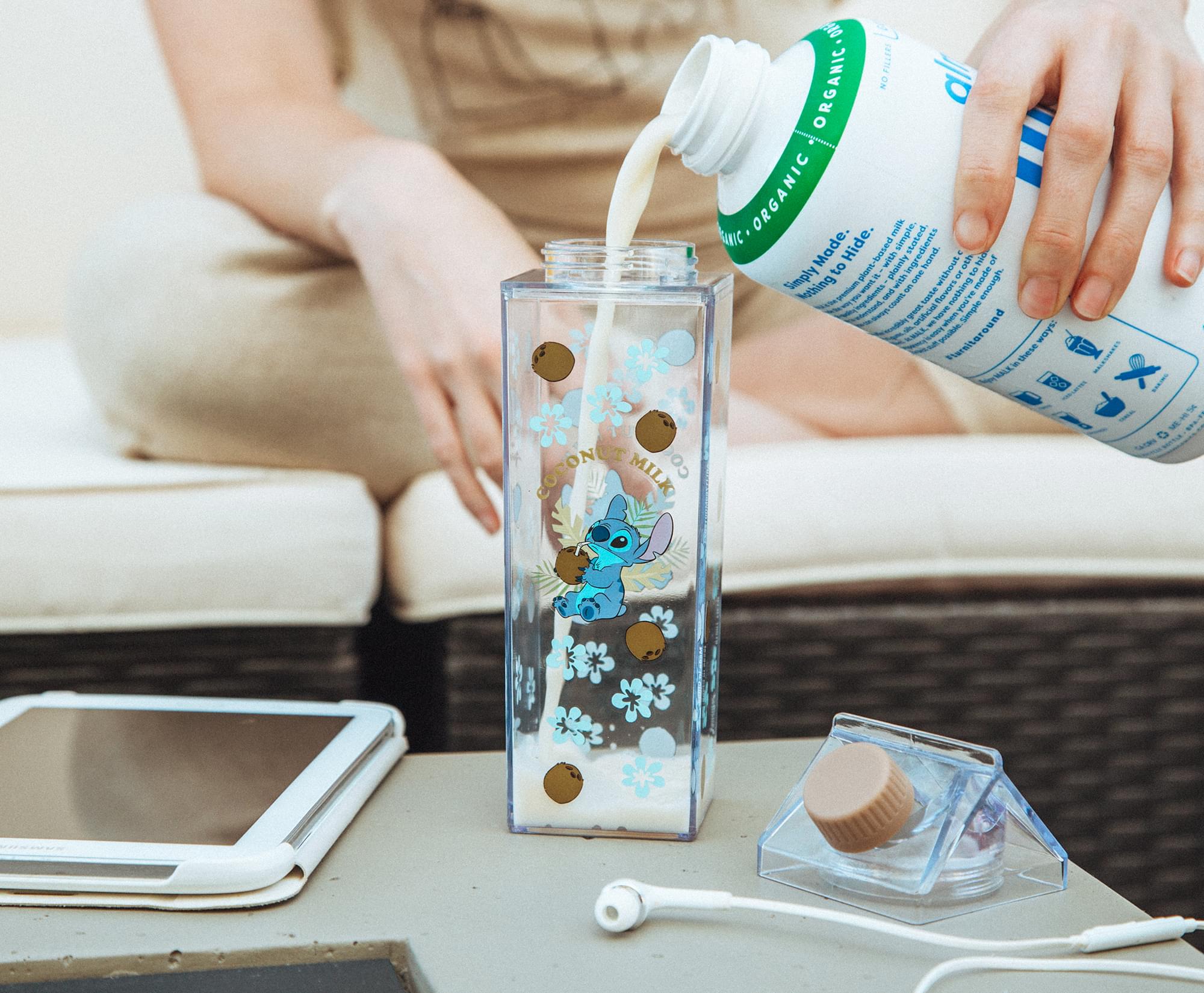 Sure, here is the corrected and grouped text:

**Product Information:**
- COCONO MILK CO PILLER ORGANIC
- Made in the USA
- Simply to Hide
- Based on simple ingredients
- Stated red ingredients
- Hide without it
- Nothing added
- Harvest around the world

**Usage Instructions:**
- Simply pour into a bottle
- 1 scoop per day
- Steer clear of phgnt

**Additional Information:**
- A simple det
- 1 harve a Simple D
- A VUANL Harsitaround IAOM
- SME

**Label on the Bottle:**
- ORGANIC
- Simply to Hide
- Made in the USA
- Harvested around the world

**Design Elements:**
- Eeyore illustration
- Floral design

**Other Items:**
- Tablet
- Earphones