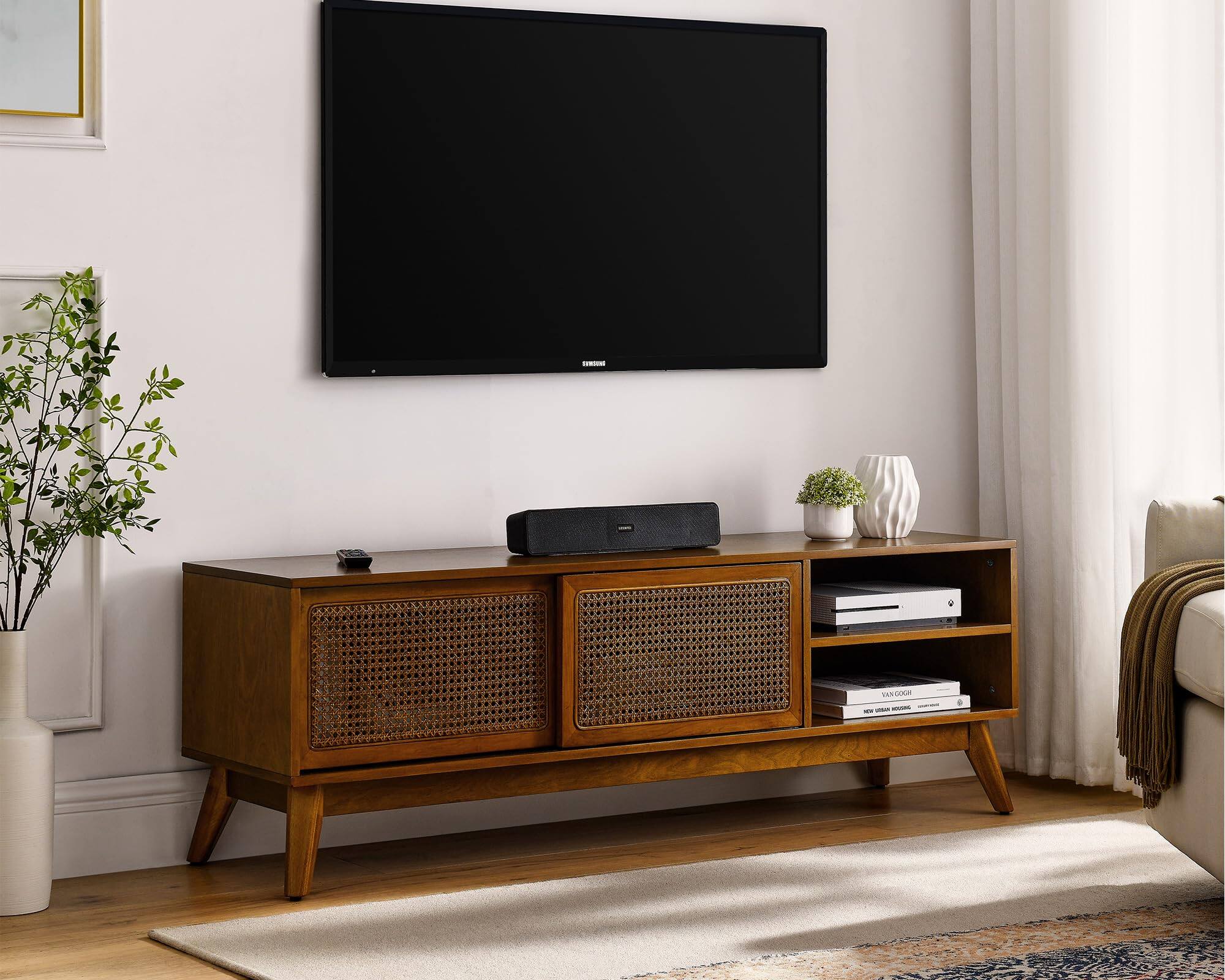 The text on the image includes:

- "SAMSUNG" (on the TV)
- "VAN GOGH" (on the book)
- "NEW VAN GOGH" (on the book)