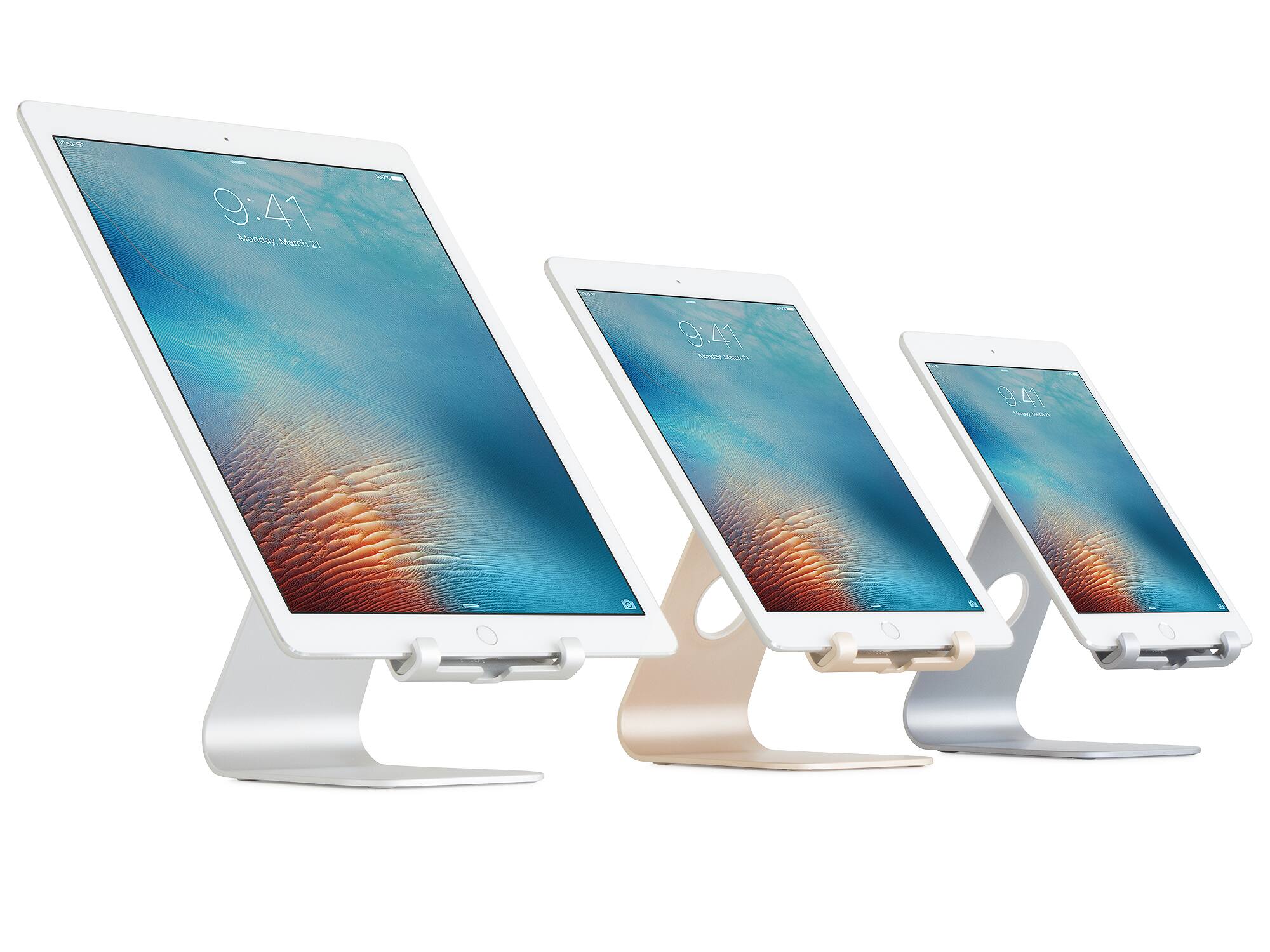 The image shows three white Apple iPad Airs sitting on stands. The stands are white and have a brown base. The iPads are arranged in a row, with each device displaying the time of 9:41.