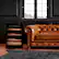 The text "8018 newoir" does not seem to be related to the image. The image shows a brown leather couch sitting in a living room, with a window in the background. The couch is positioned next to a wooden cabinet or a storage unit. The scene appears to be a cozy living space, possibly in a house.