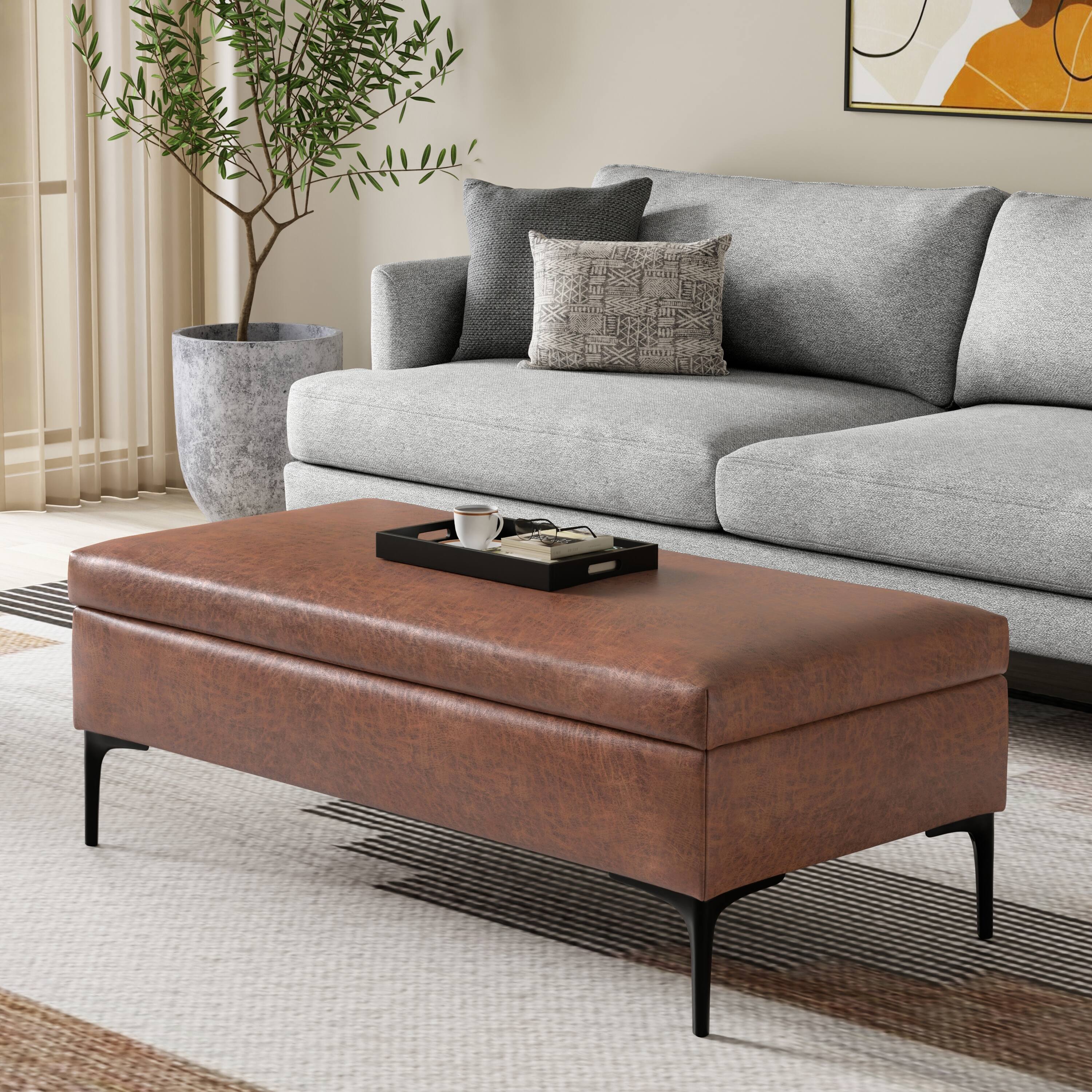 Angle. Simpli Home - Rebecca 48 inch Mid Century Modern Storage Ottoman with Lift up Lid in Distressed Saddle Brown Faux Leather, Assembled - Distressed Saddle Brown.