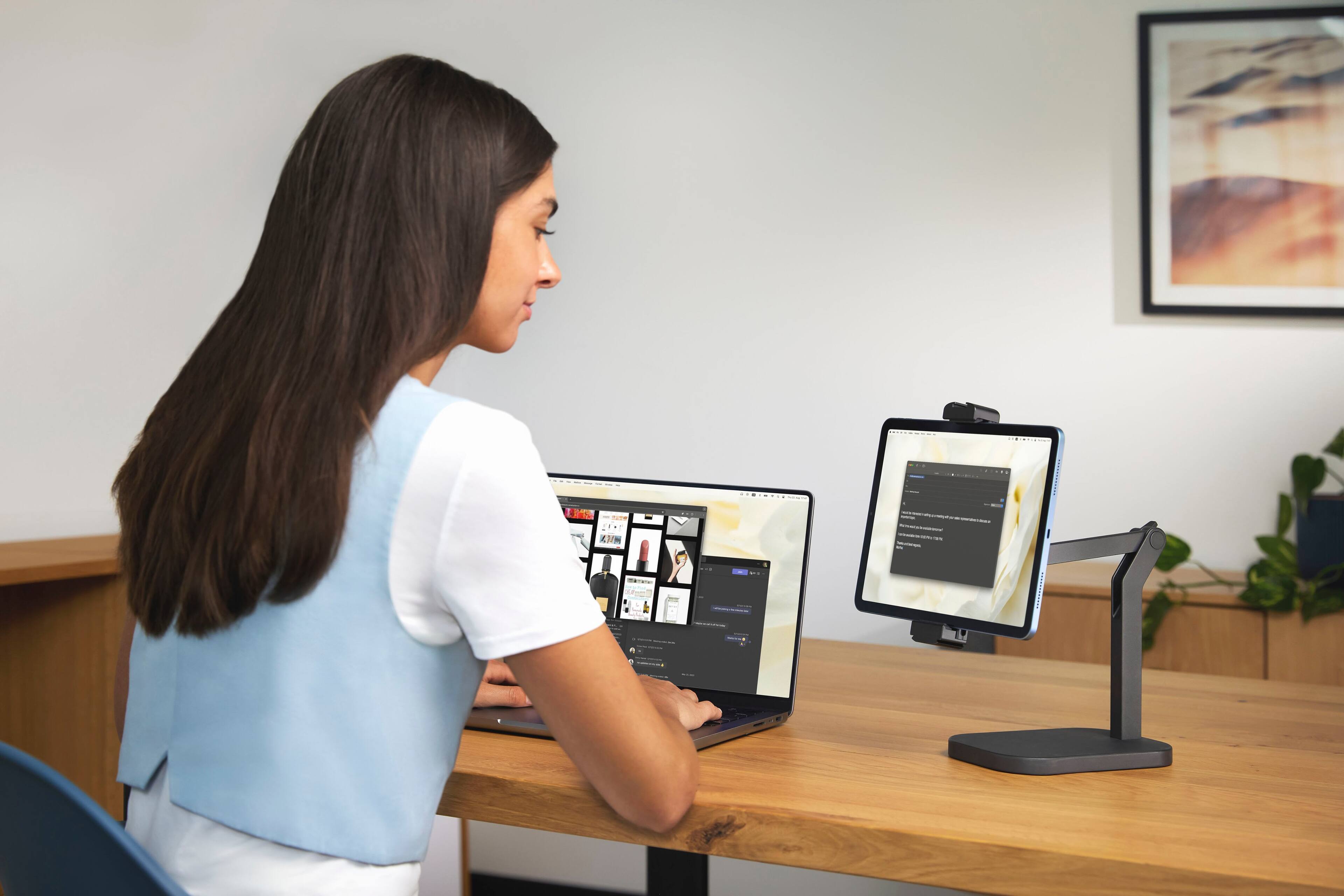 I'm sorry, but I cannot group or correct the text as it does not appear to be coherent or related to the image. The image shows a woman sitting at a desk with a laptop and a tablet, and there is no text that can be grouped or corrected.