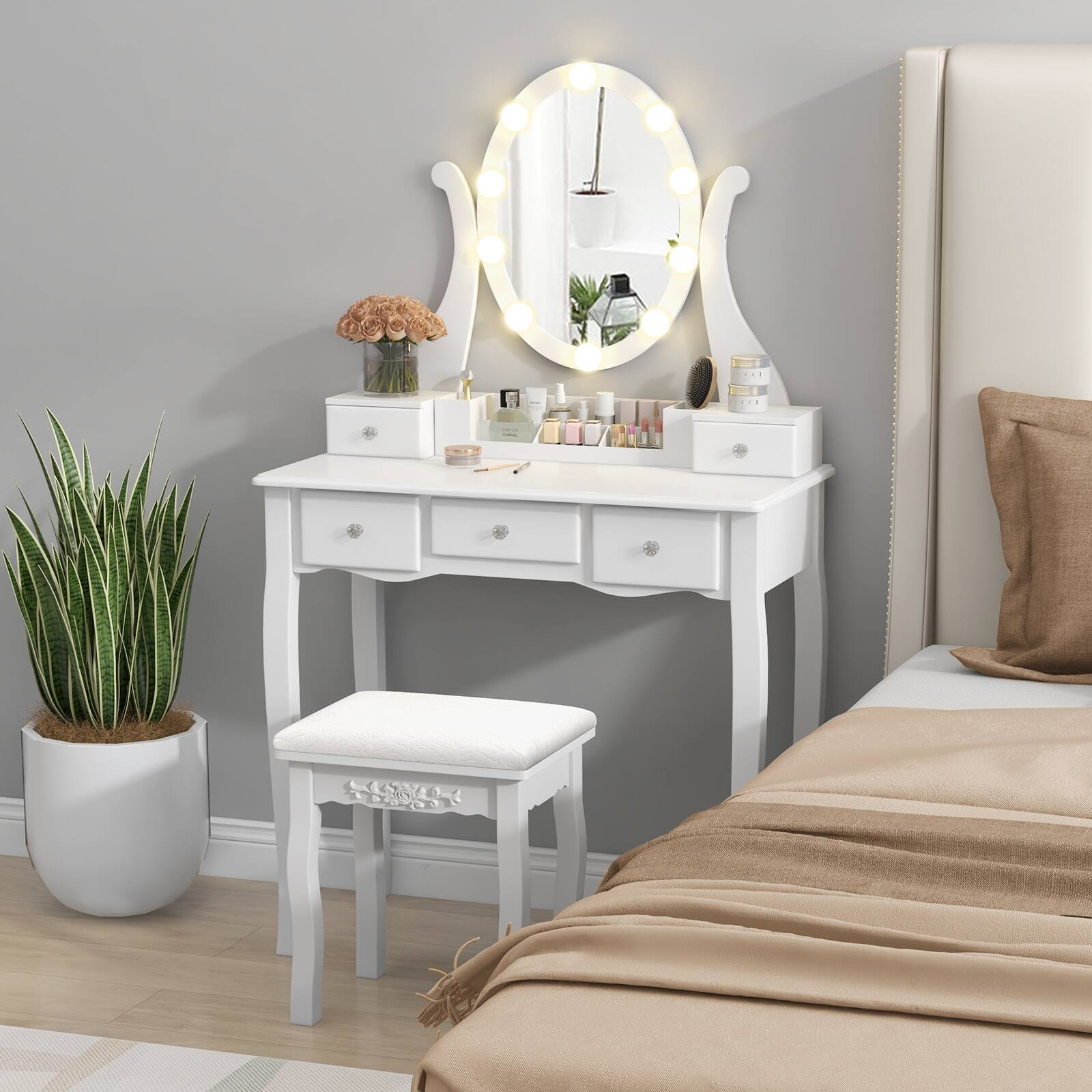 The image does not contain any text to group or correct. It shows a vanity setup with a mirror, makeup items, and a stool in a bedroom.