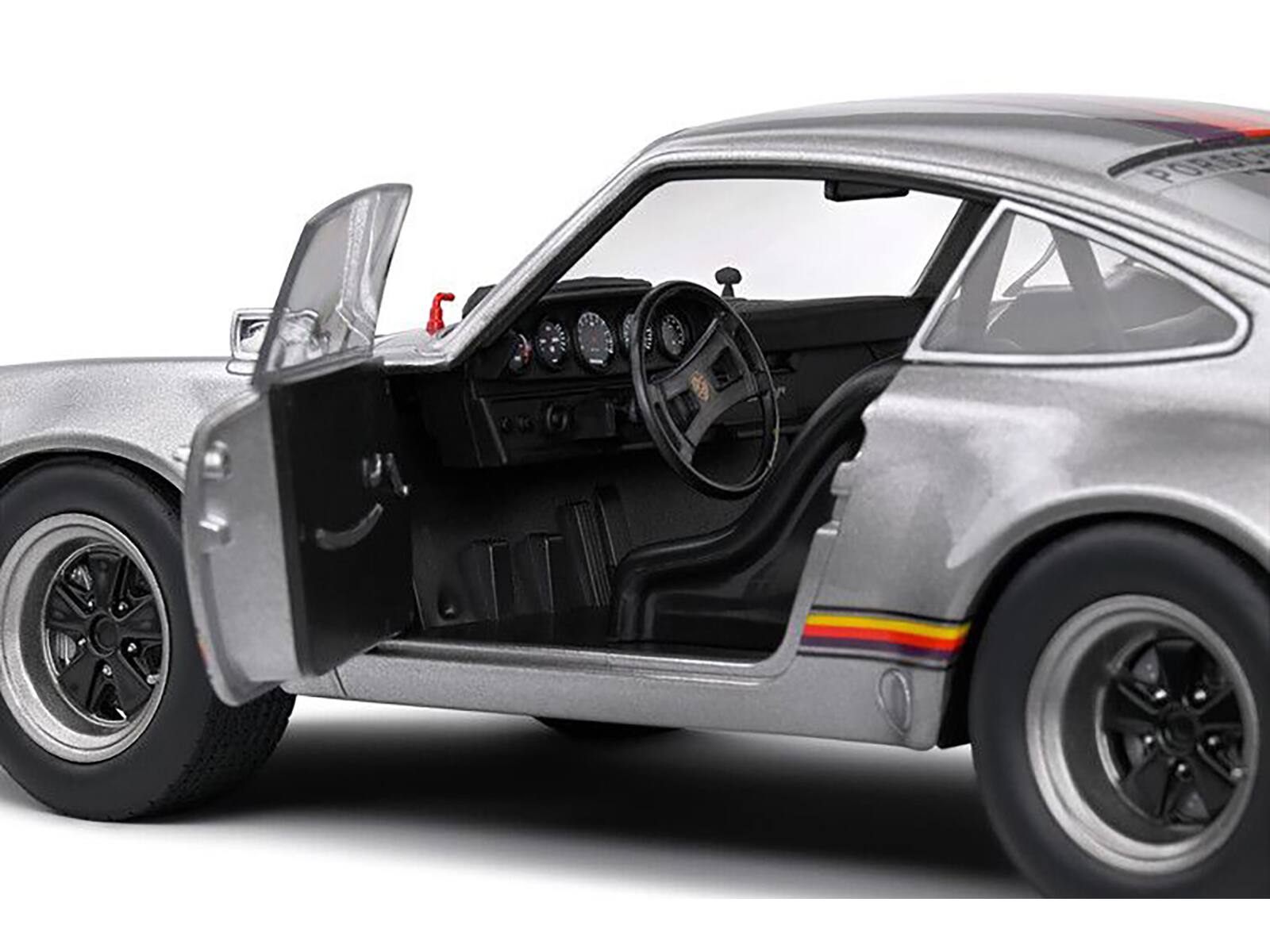 Left. Solido - 1973 Porsche 911 RSR "Kremer" Silver Metallic with Stripes 1/18 Diecast Model Car by Solido - Silver Metallic.