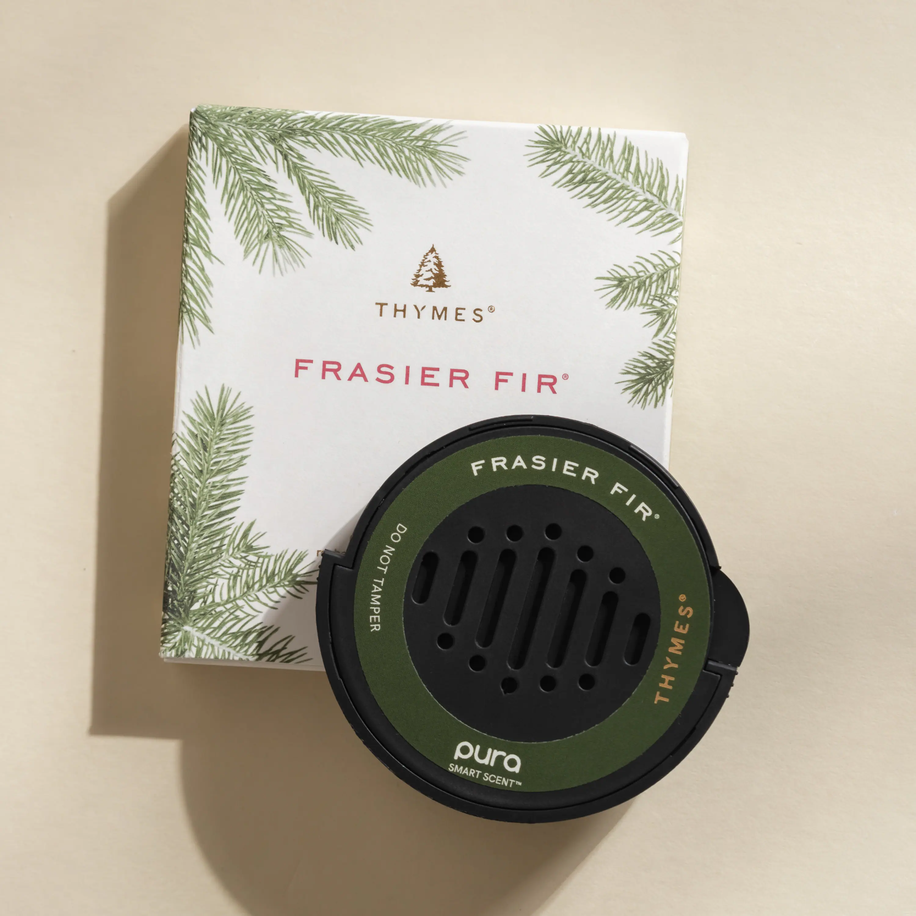 Thymes Frasier Fir is a scent that should not be tampered with. The scent is described as pura, which suggests a natural and unaltered aroma. The box and the scent container are both green in color, adding to the overall appeal of the product.