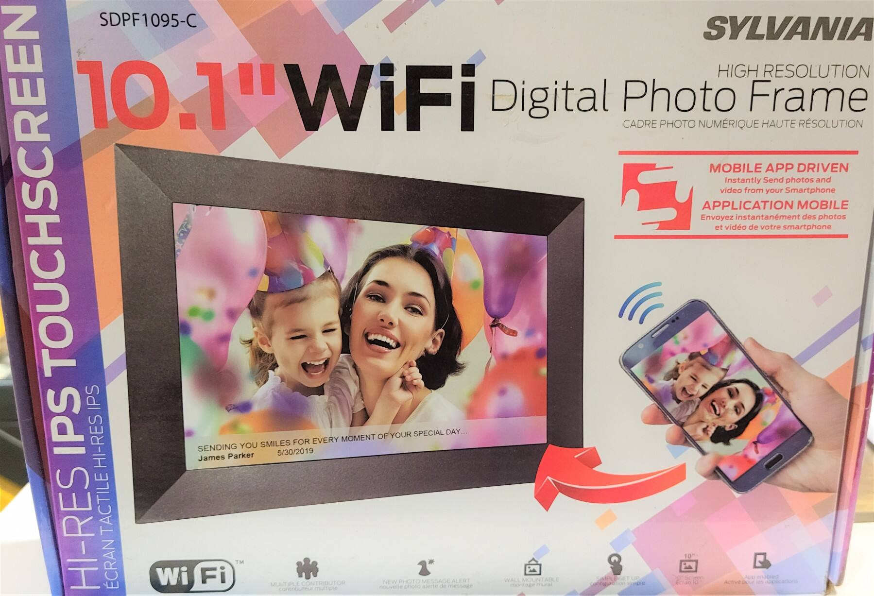 Sure, here is the corrected and grouped text from the image:

---

**SDPF1095-C**

**SYLVANIA**

**10.1" WiFi Digital Photo Frame**

**HIGH RESOLUTION**

**CADRE PHOTO NUMÉRIQUE HAUTE RÉSOLUTION**

**MOBILE APP DRIVEN**

**APPLICATION MOBILE**

**Instantly Send photos and video from your Smartphone**

**Envoyez Instantanément des photos et vidéo de votre smartphone**

**SENDING YOU SMILES**

**James Parker**

**5/30/2019**

**FOR EVERY MOMENT OF YOUR SPECIAL DAY...**

**HI-RES IPS TOUCHSCREEN**

**ÉCRAN TACTILE HI-RES IPS**

**WIFI**

**MULTIPLE CONTRIBUTOR**

**NEW PHOTO MESSAGE ALERT**

**WALL MOUNTABLE**

**10"**

**Active de plusieurs applications**

**Configuration multiple**

---

This text is organized to reflect the information on the product packaging.
