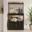 The image features a black shelf with a variety of items on it. There are several bottles, including some that are labeled "Robusta." Additionally, there are cups and a bowl on the shelf. The shelf is placed in a kitchen setting, with a potted plant nearby.