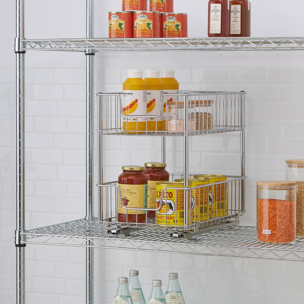 The image shows a shelf with various bottles and cans, including a bottle of orange juice, a bottle of soda, and a bottle of water. There are also some cans of food on the shelf. The shelf is located in a kitchen, and the items are arranged in a way that allows for easy access and organization.
