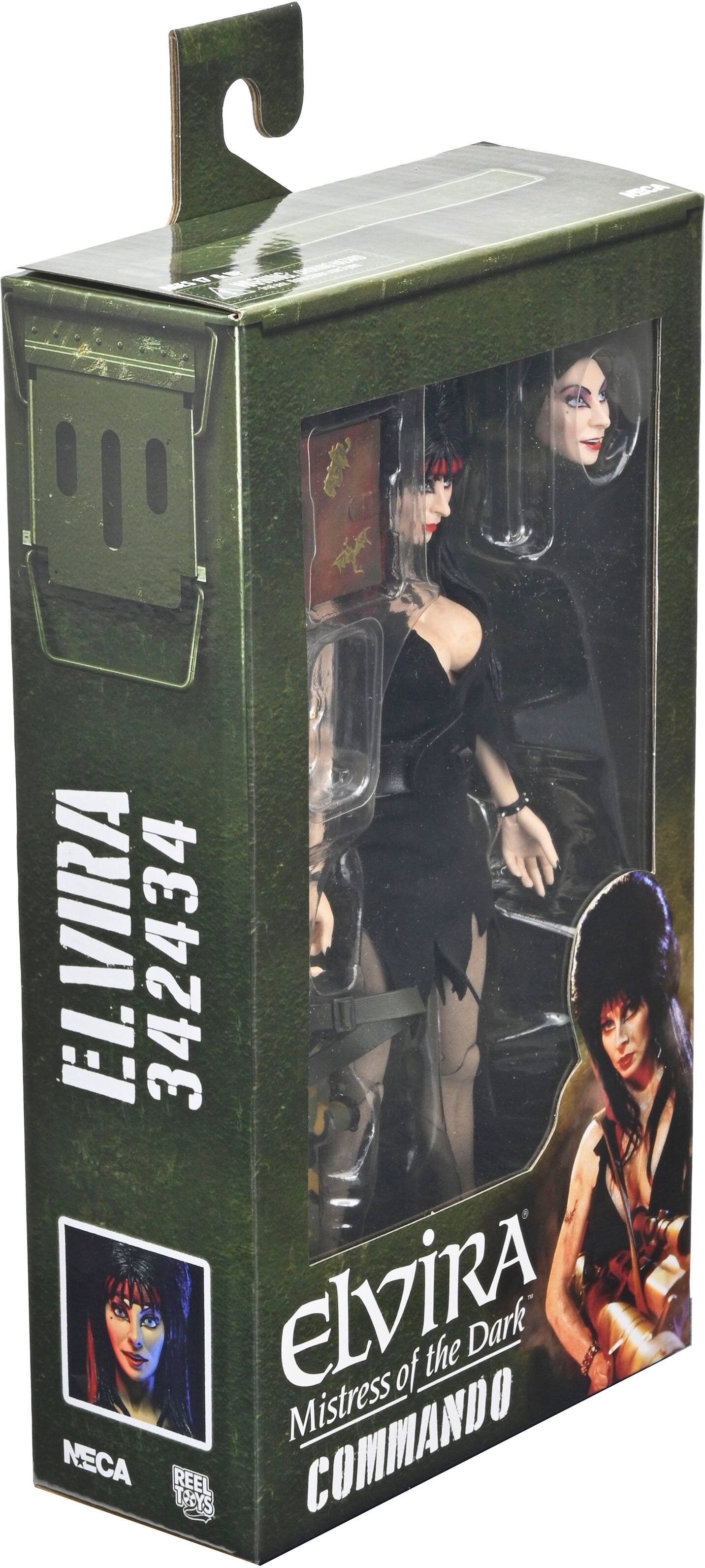 The image features a box containing a figurine of Elvira, the Mistress of the Dark. The box is green and has a picture of the figurine on it. The figurine is a part of the Neca Reel Toys collection.