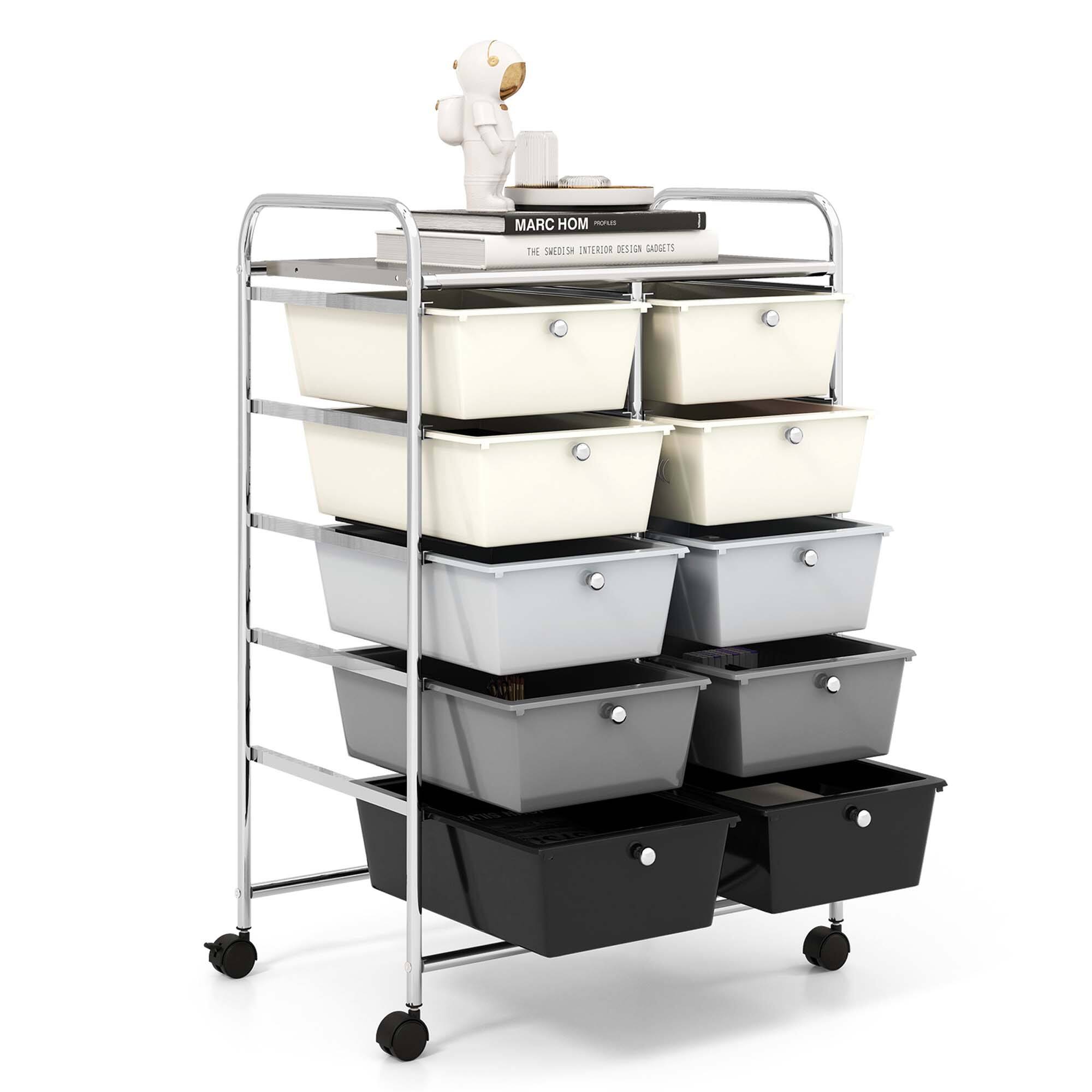The image features a cart with several stacks of plastic containers, including bins and drawers. The containers are arranged in a way that they can be easily accessed and utilized. The cart is placed in a room, possibly a kitchen or an office space, and it serves as a functional storage solution for various items.