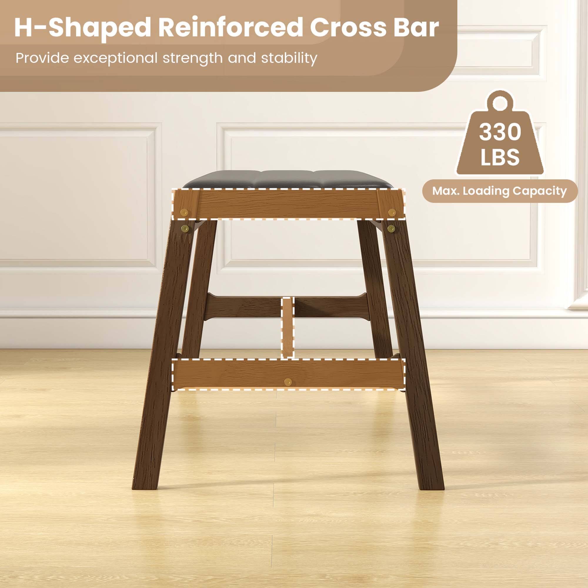 The image features a wooden stool with a reinforced cross bar. The cross bar is designed to provide exceptional strength and stability, ensuring that the stool can support a maximum loading capacity of 330 lbs. The stool is made of wood and is placed on a wooden floor.