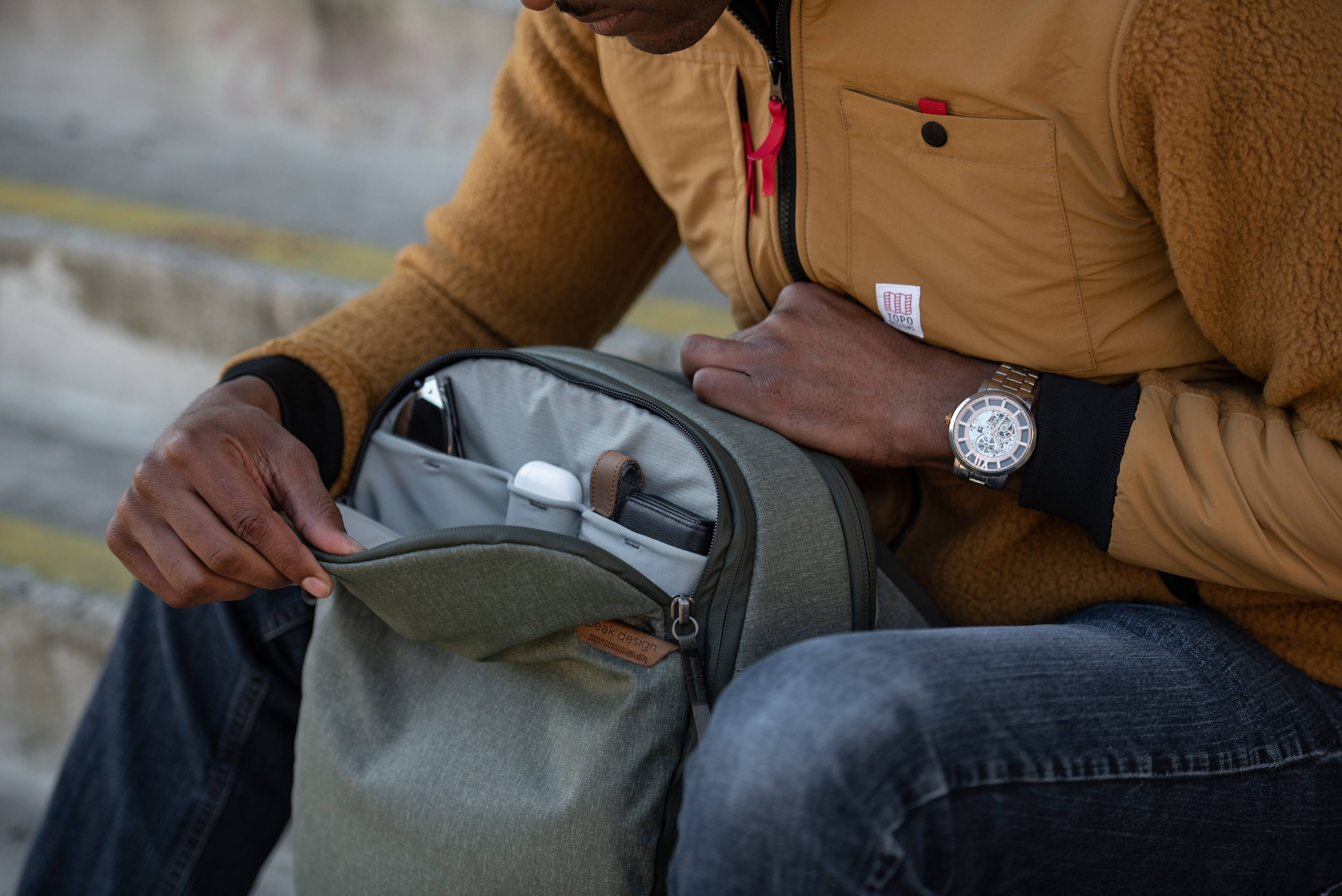 The man is wearing a watch with a design that says "I weak."