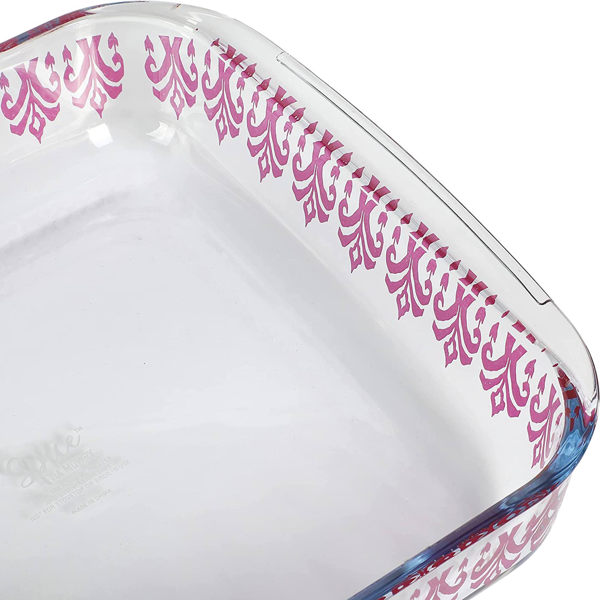 The image shows a clear glass bowl with a pink and white design on it. The bowl is empty, and it appears to be made of glass. The bowl is placed on a white background, making it stand out prominently.