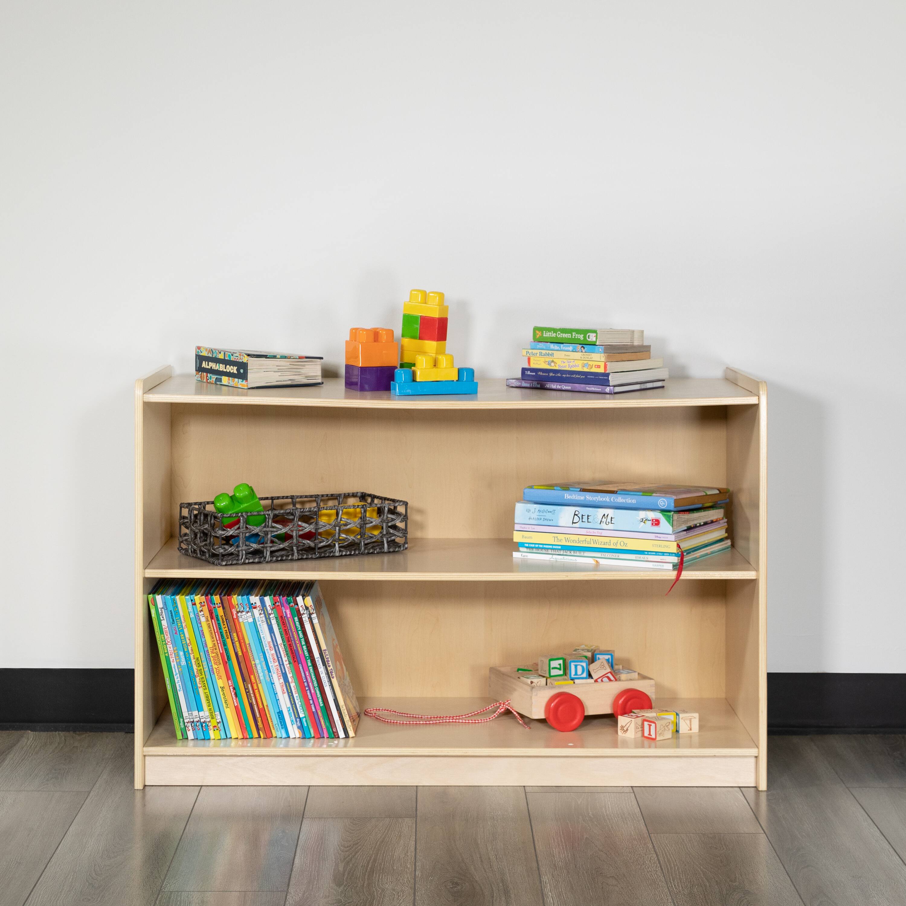 Sure, here is the corrected and grouped text from the image:

---

**Top Shelf:**
- ALPHABET BOOK
- Little One Foot

**Middle Shelf:**
- BEE MLE
- The World of Color

**Bottom Shelf:**
- Various colorful books

---

**Toy on Bottom Shelf:**
- D
- 1

---

**Text on the Toy:**
- BEE MLE

---

**Text on the Box:**
- ALPHABET BOOK

---

**Text on the Books:**
- Little One Foot
- The World of Color

---

**Text on the Toy:**
- D
- 1

---

**Text on the Box:**
- ALPHABET BOOK

---

**Text on the Books:**
- Little One Foot
- The World of Color

---

**Text on the Toy:**
- BEE MLE

---

**Text on the Box:**
- ALPHABET BOOK

---

**Text on the Books:**
- Little One Foot
- The World of Color

---

**Text on the Toy:**
- D
- 1

---

**Text on the Box:**
- ALPHABET BOOK

---

**Text on the Books:**
